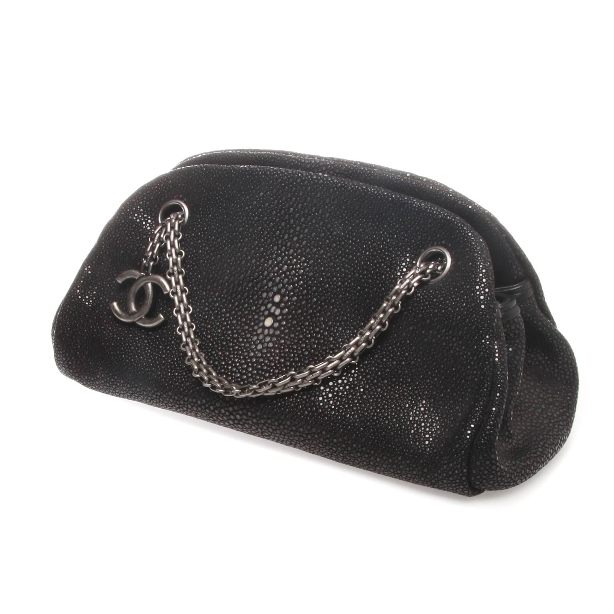 A stunning-rare black stingray half moon tote from CHANEL.
It features an open top design, a chain shoulder strap, a logo charm, an internal zipped pocket, an internal logo stamp and multiple interior compartments. 
Fabulous black stingray half moon
