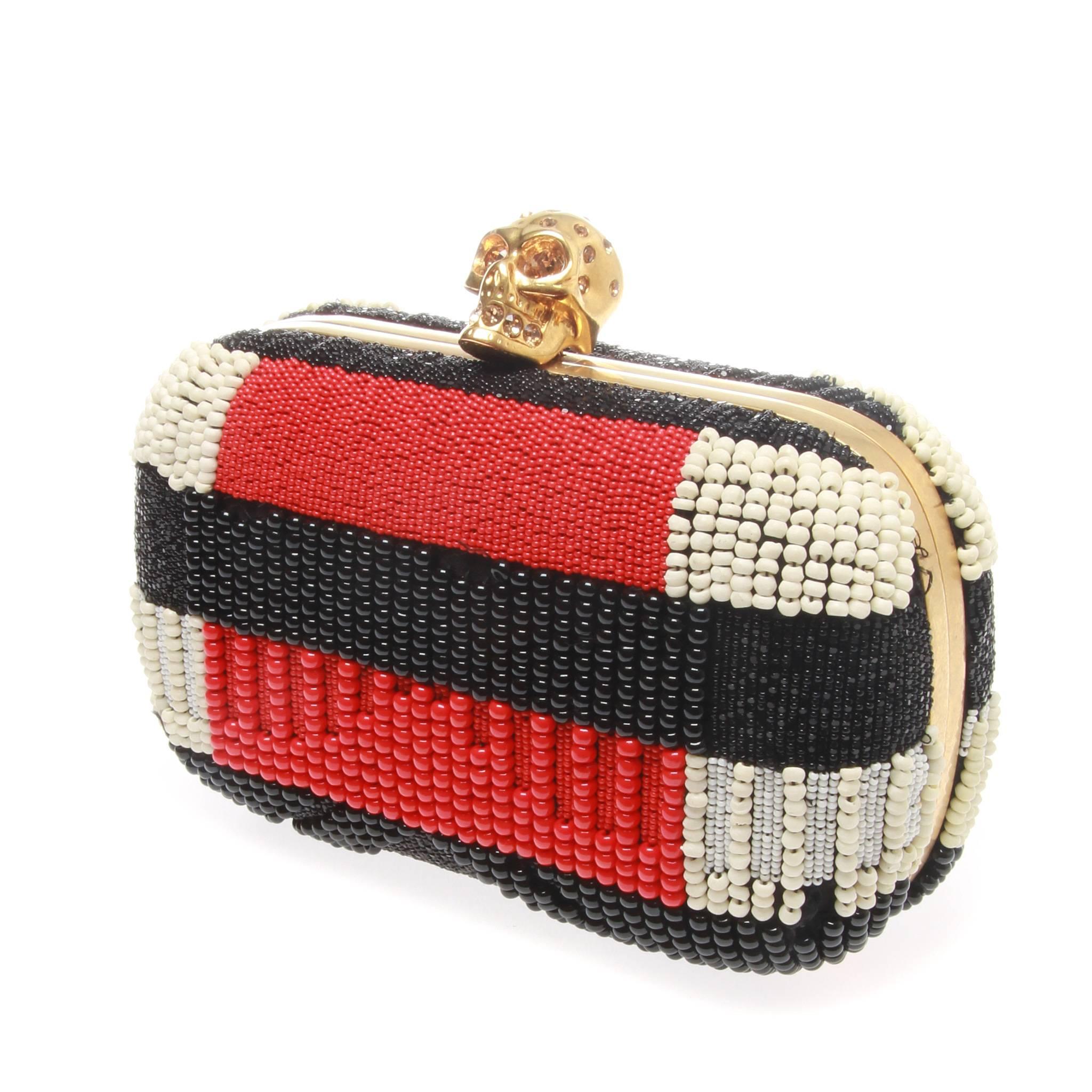 Alexander McQueen Beaded Clutch

An All-over red, black, white bead embellishment.
Beautifully crafted Gold-tone frame.
Swarovski crystal-embellished skull clasp.
Leather-lined interior
Closure/Opening: Skull Clasp
Interior: Leather Lining
