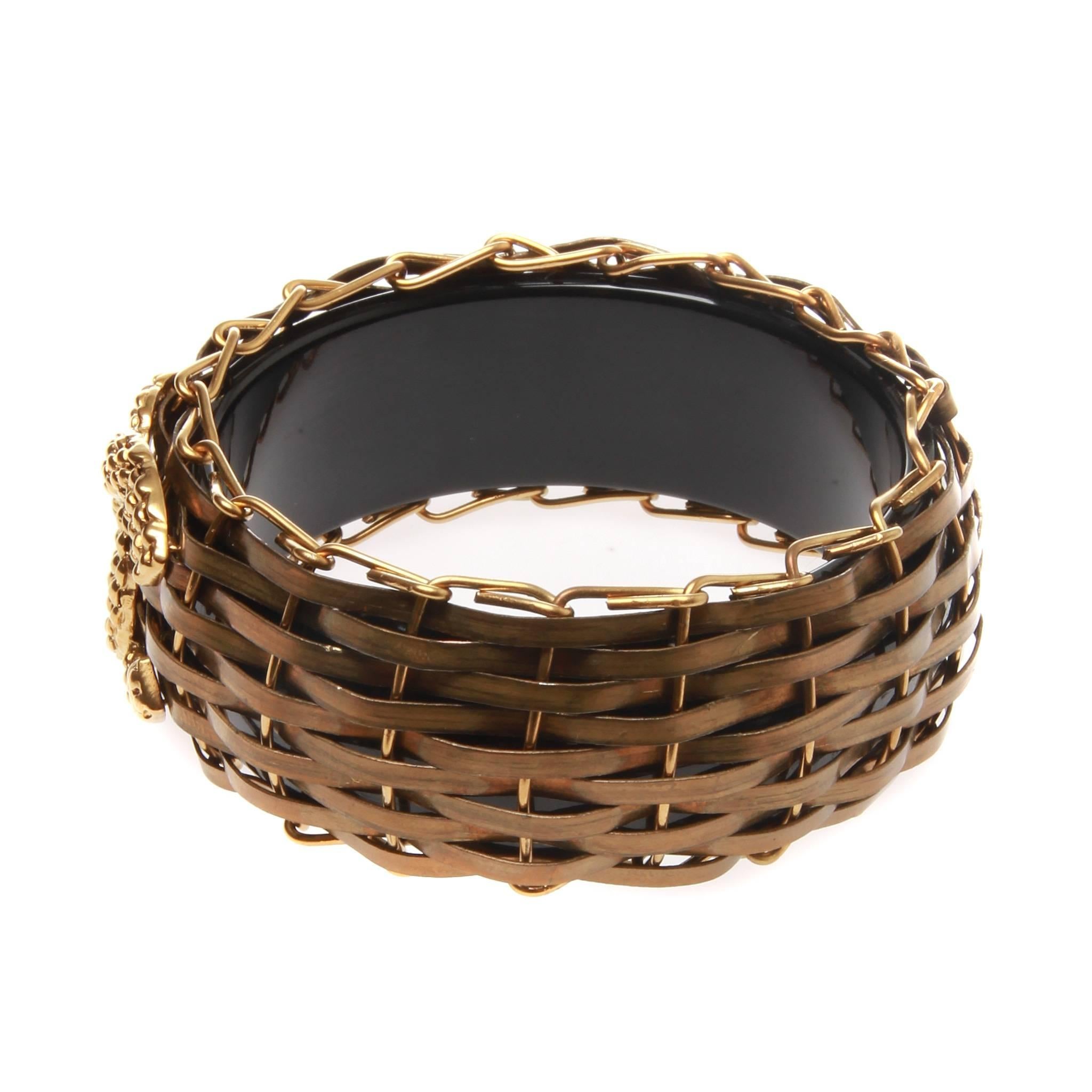 CHANEL Bronze Bamboo Basket Resin Bangle Bracelet

A Pristine-Rare bronze bamboo basket resin bangle bracelet by CHANEL.
This well made artisan piece is from the Chanel 2008 resort collection and has now become very hard to find.
To give a peek of