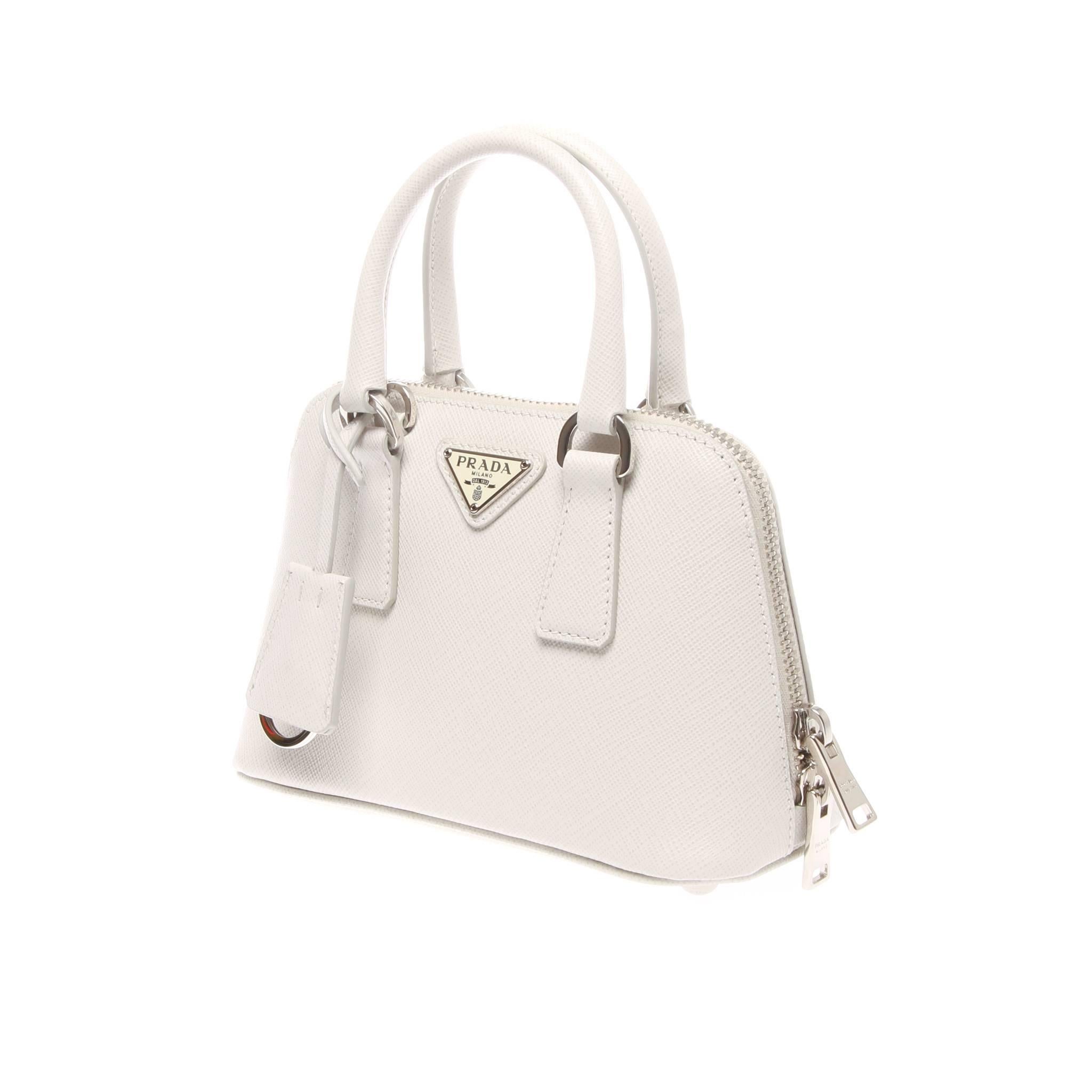 Prada Saffiano Lux Mini Promenade Bag

Beautifully structured in a dome silhouette, this petite satchel features luxe metallic Saffiano calf leather and an optional strap for wearing cross body.
It features double top handles, 2½" drop,