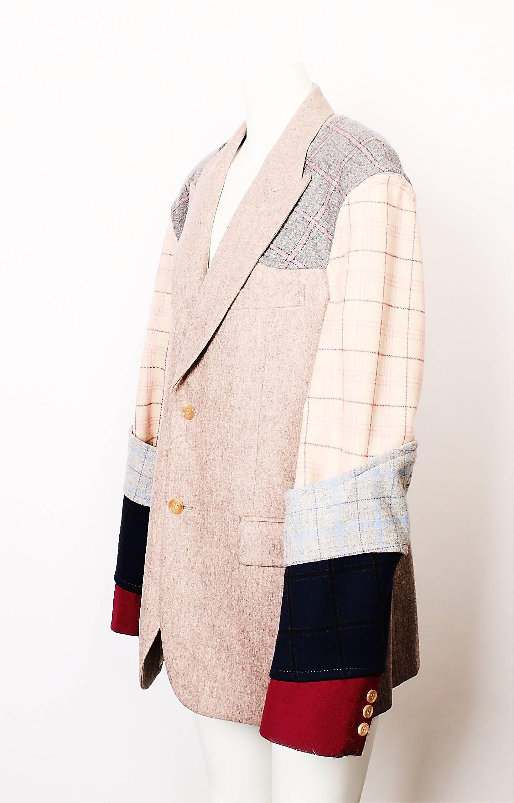 Amazing Comme Des Garcons Homme Plus men's blazer features multi panelled checked and solid segments. Single breasted with single back vent. 
Taupe main colour with raspberry coloured cuffs. (looks slight red in images).
Vents at underarm and the