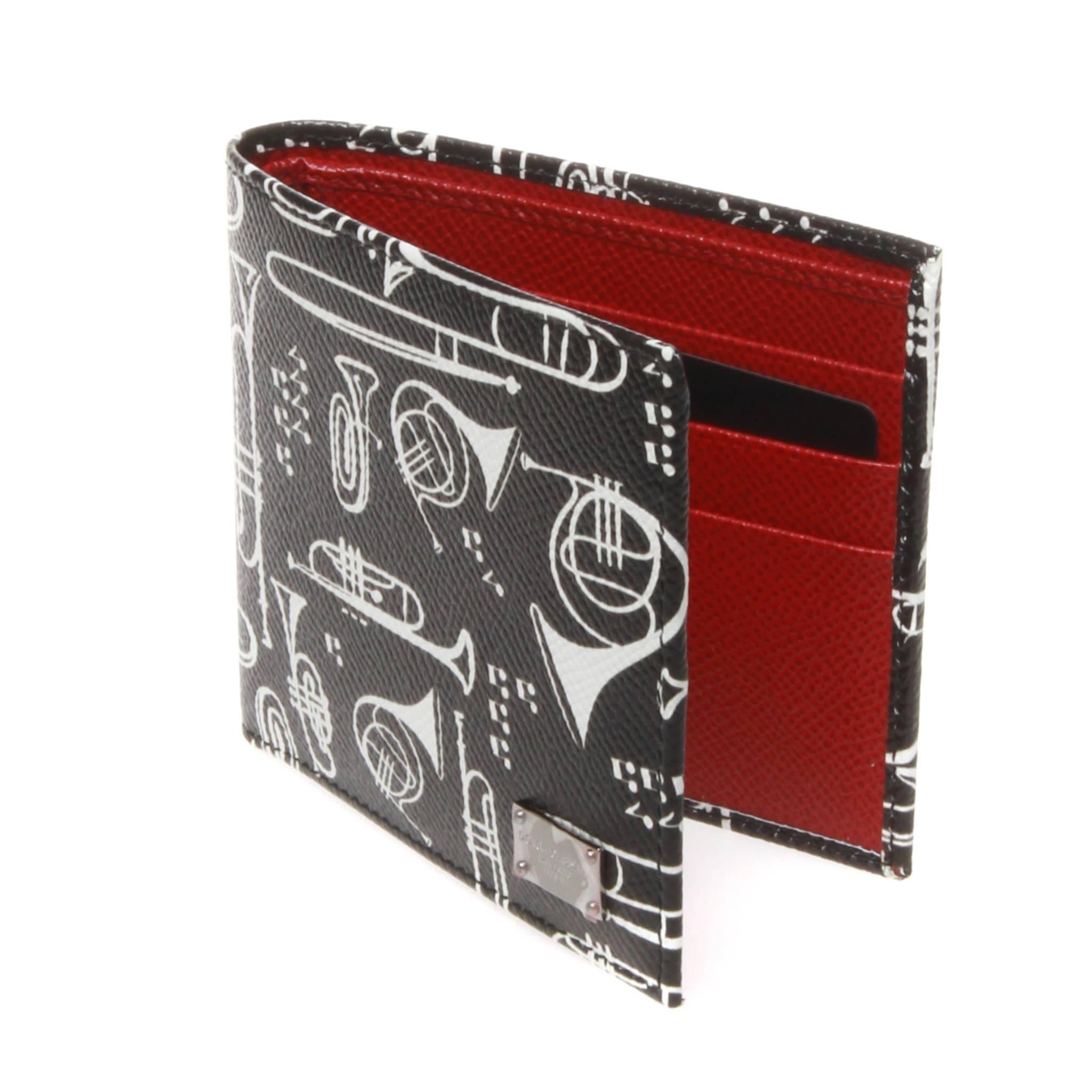 Dolce and Gabbana saffiano leather bi-fold wallet showing an all-over contrasting black and white brass horn motif. Interior is a rich red saffiano and has eight card slots, four slots for receipts and a bill section. Small silver brand plaque at