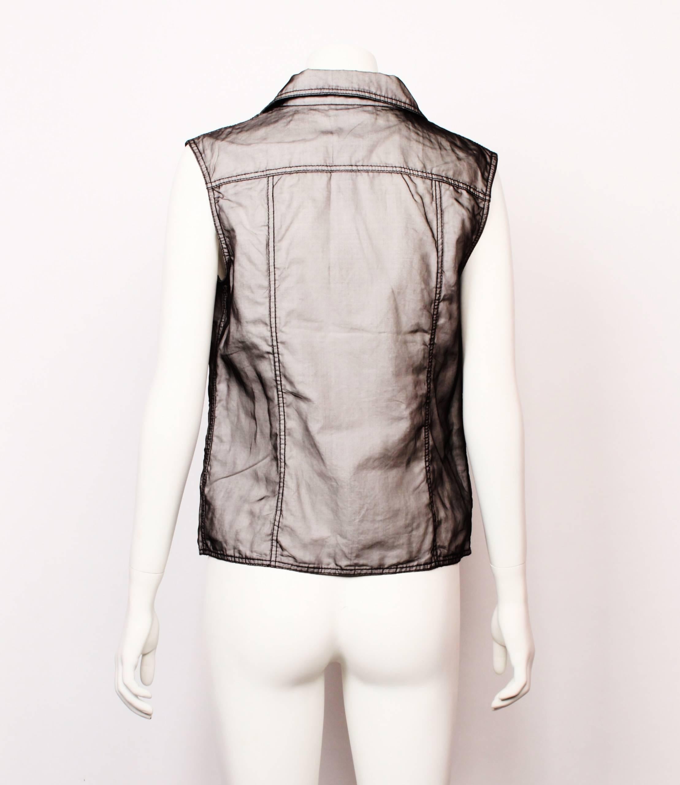 CHANEL Double Breasted Vest. Black organza is layered over white cotton to create a shot affect. 
Features black contrast top stitching, welt pockets and gun metal decorative Chanel cc logo buttons.