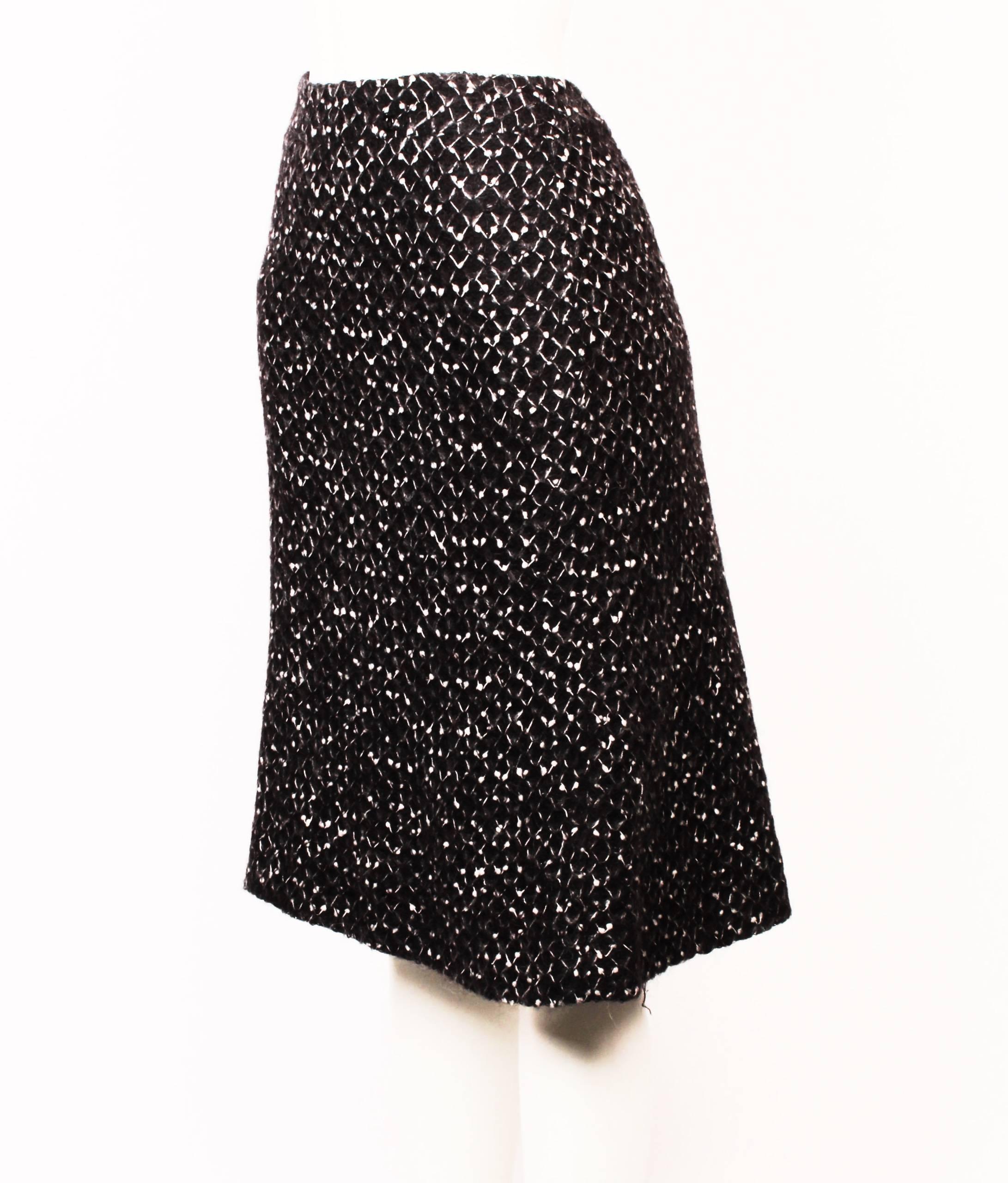 Gorgeous Chanel wool knit skirt in black, grey and white honeycomb knit. 
The top features a boat neck and a curved knitted yoke that contours the hip. The skirt is A-line and fully lined. Made in France. Size 46.
