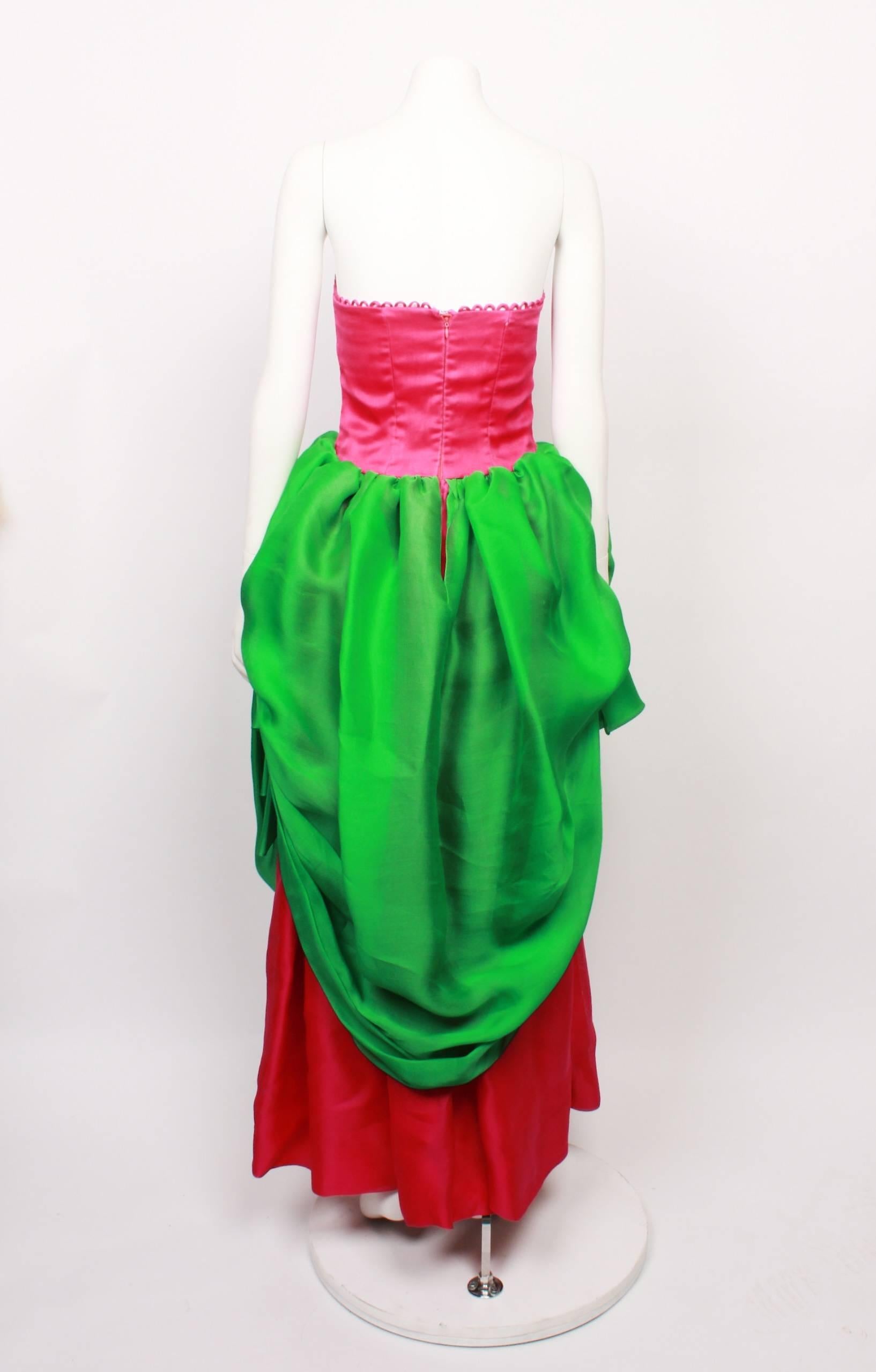 Striking Carolina Harrera Red Carpet Gown in hot pink and lime green faille. This is an original runway sample and most likely a one off couture piece. 
The gown is strapless and has a beautiful rouleau loop decorative feature around the top edge.