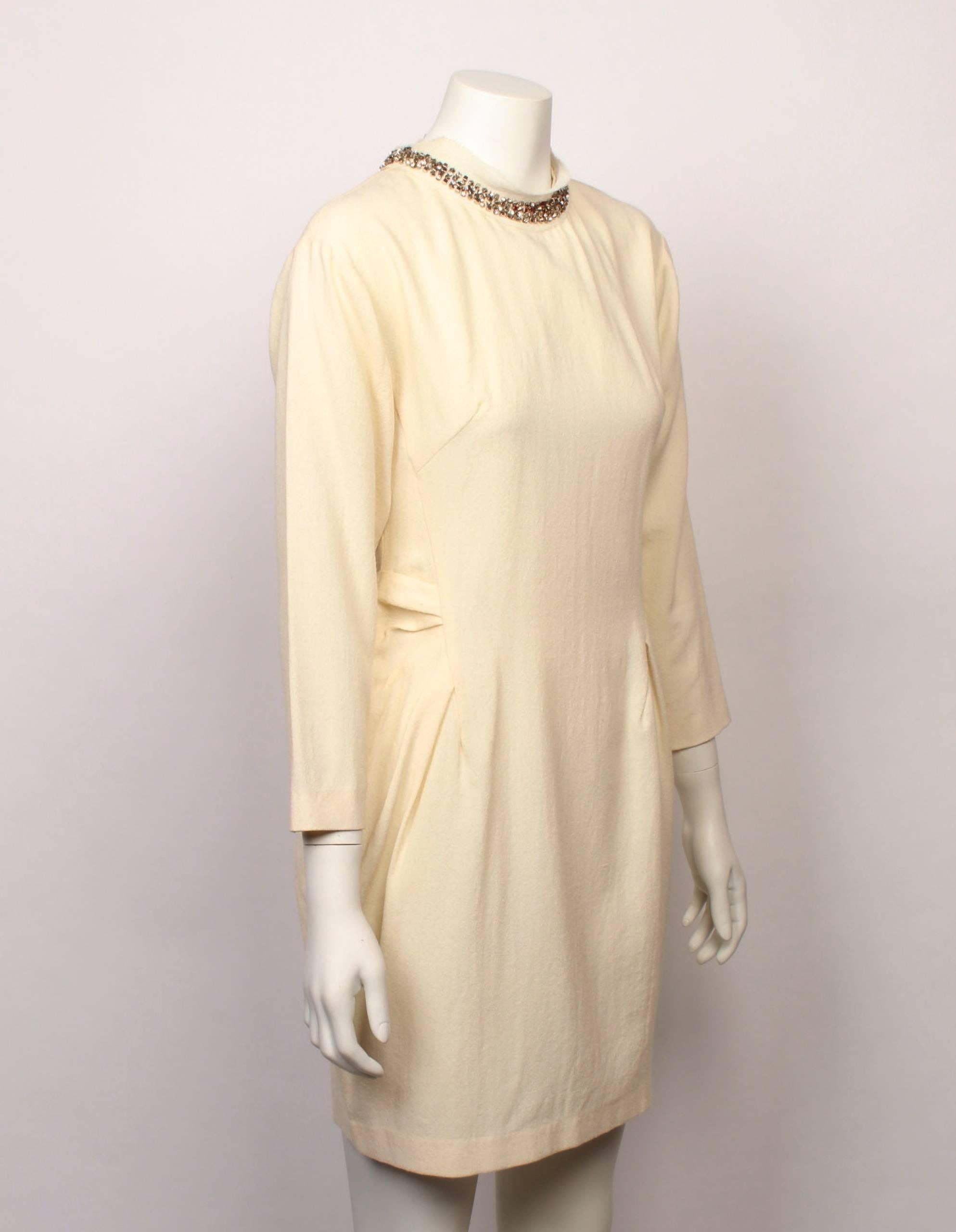 Chic Lanvin Paris ivory crepe long sleeve cocktail mini dress with beautiful metallic beading around neckline. Features gentle tucks and darts at side of waistline. Back metal zip closure. 
Made in France. Size Small.
