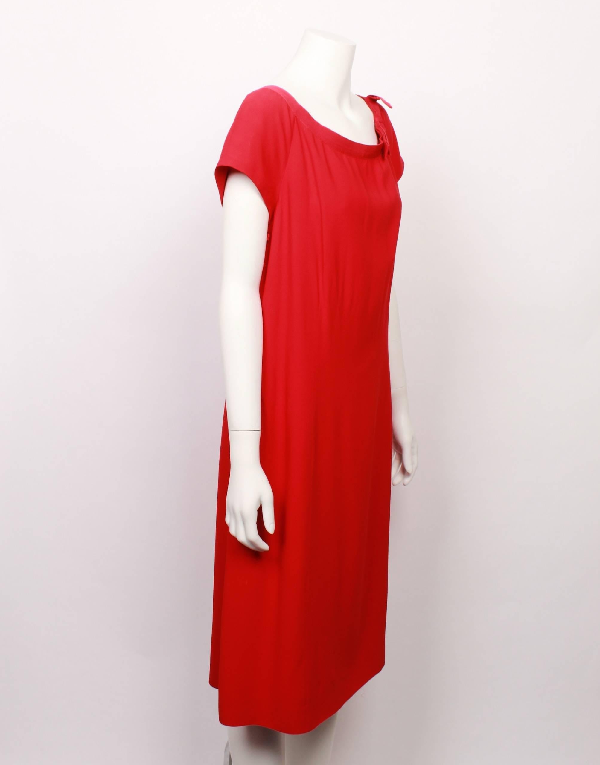 Classic Moschino bright red shift dress features a scooped neckline with a lovely grosgrain ribbon trim and flat bow detail.  Cap sleeves. 
Fully lined with side invisible zipper closure. 
