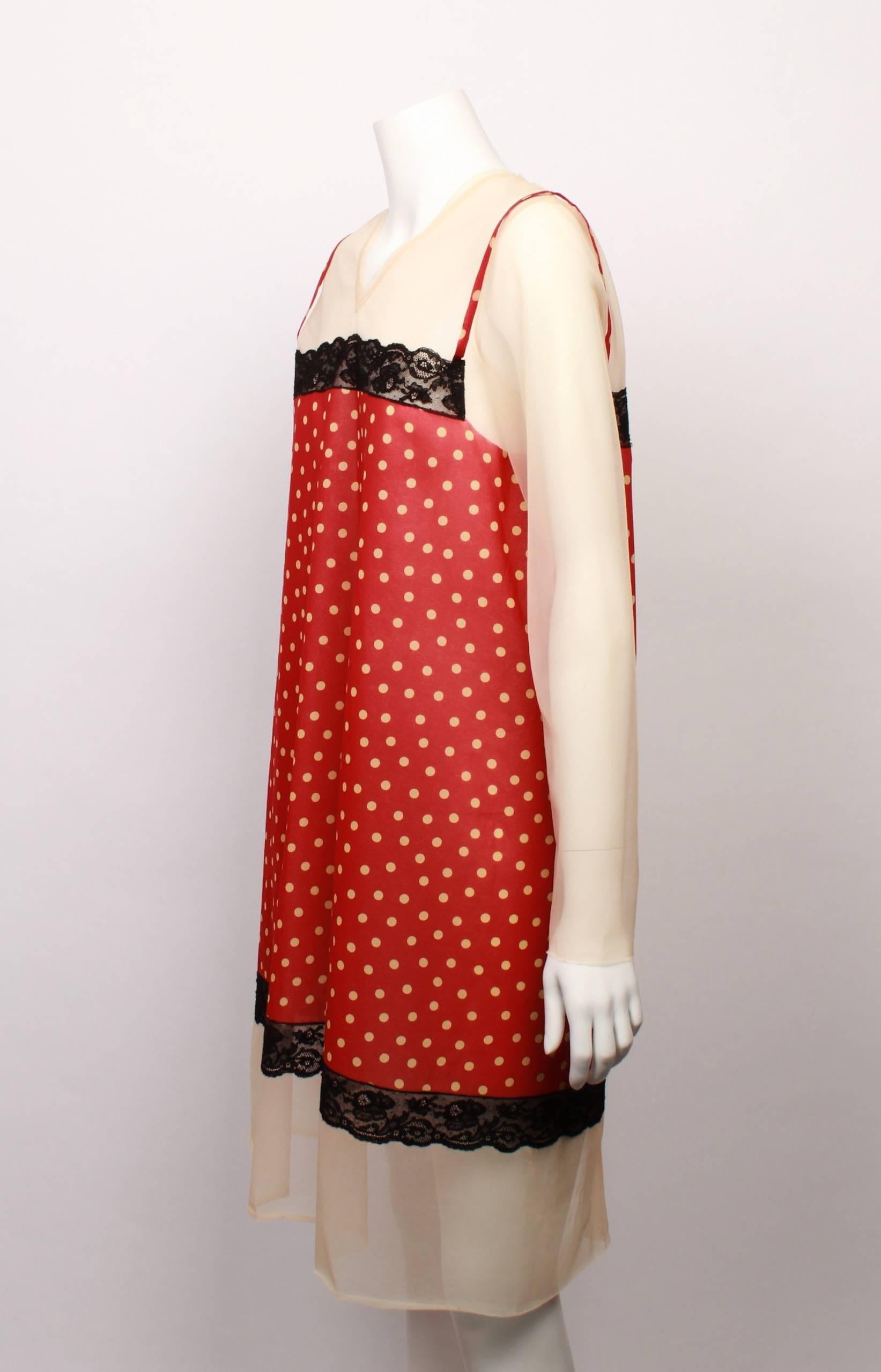 FINAL SALE - NO FURTHER DISCOUNT
Madam Virtue & Co

Jean Paul Gaultier tie back V-neck overlay dress in panels of red and cream polka dots with cream sheer chiffon sleeves with a raw edged finish.  The dress features a black lace trim around the