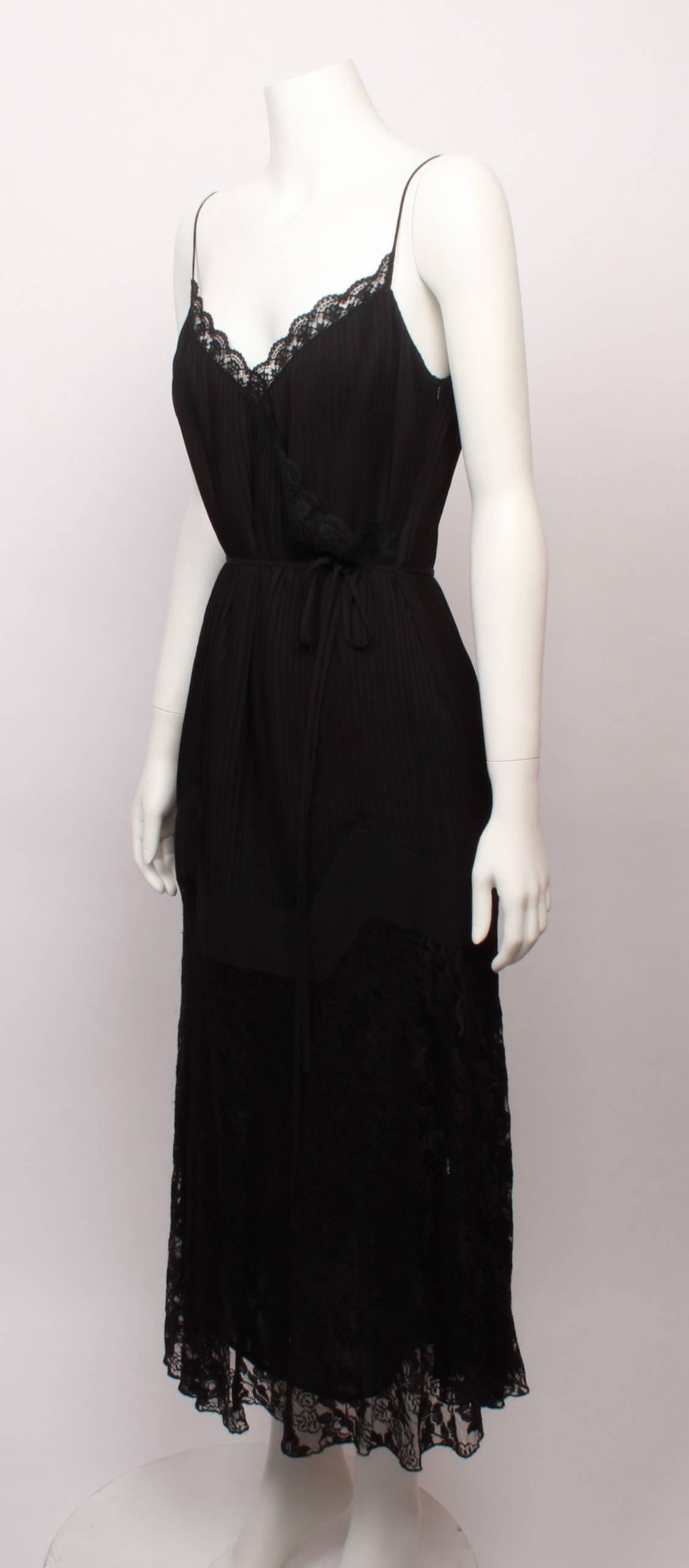 Final Sale  - No further discounts

John Paul Gaultier Maille black pleated cocktail dress. 
Features spaghetti straps and wrap front knife pleated bodice with delicate lace trim. Slightly flared pleated skirt with solid and lace curved panels at