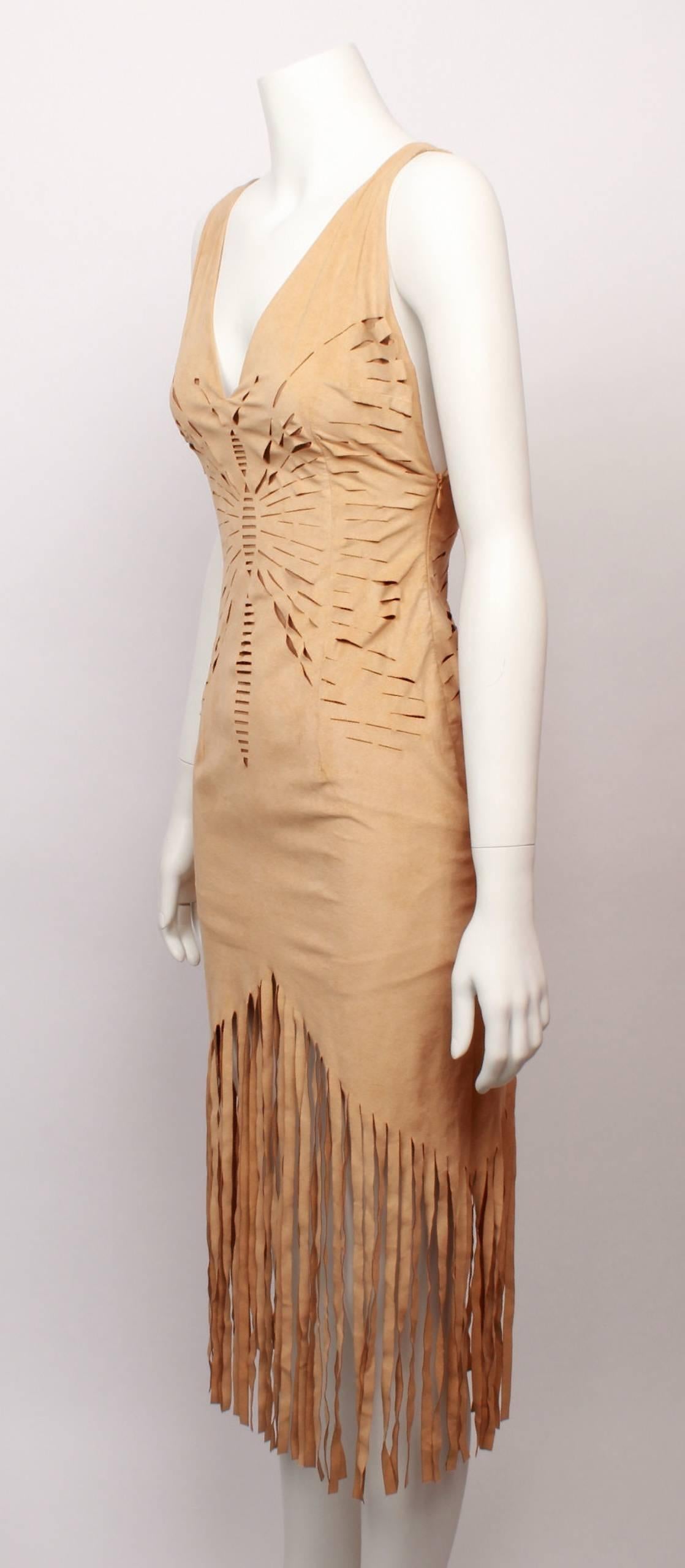 Incredible Christian Dior sleeveless beige 'Suede Look' dress features laser cutting on the front and back torso in the shape of a butterfly and dramatic fringed hemline. 
The dress is sleeveless with V shaped necklines and body con fitted