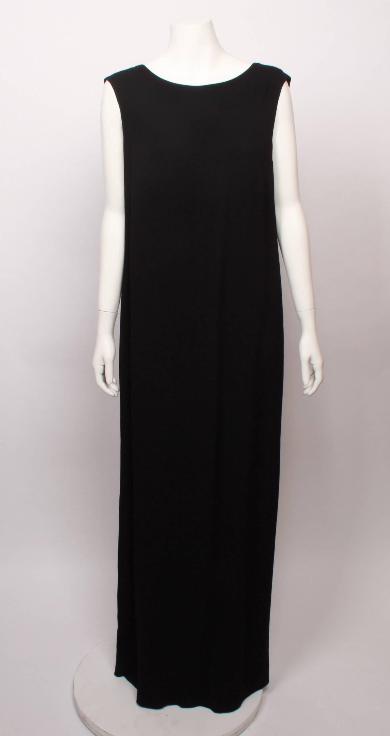 A fantastic example of timeless Maison Martim Margiela. Chic and minimal black sleeveless maxi sheath dress with satin panel featuring nickel zipper trim. Open V slit neckline.
 A must have for the MMM collector. 
In very good condition. Made in