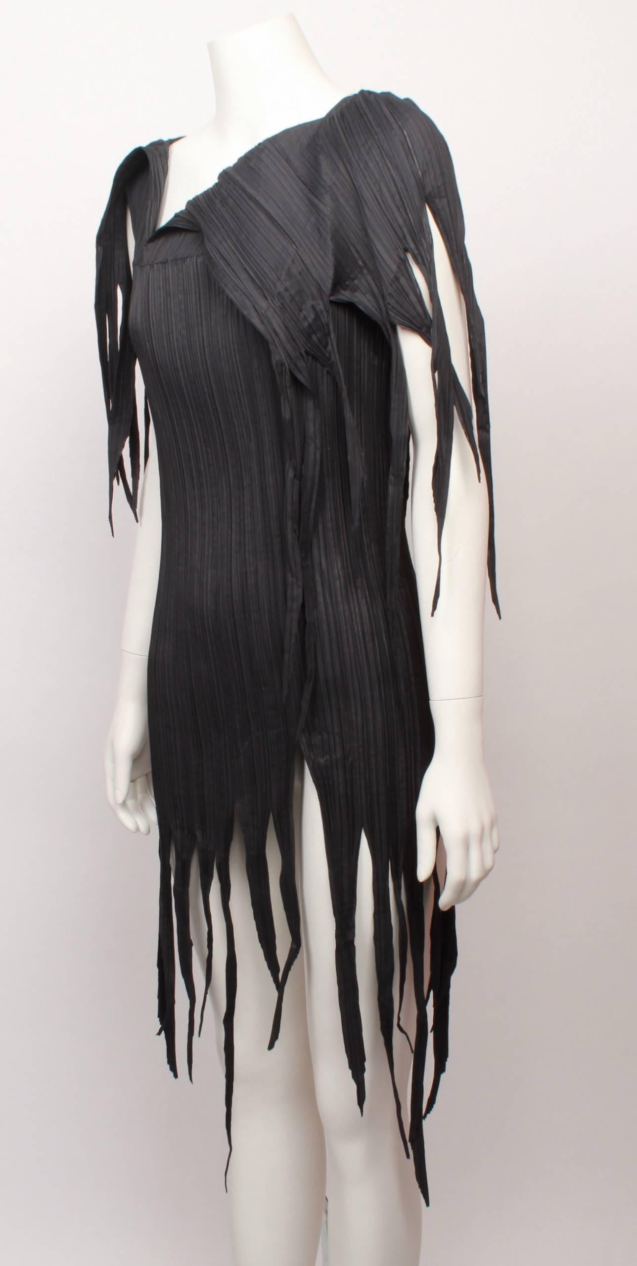 , Issey Miyake dark olive/grey long pleated top with jagged fringed  hemline and asymmetric neckline in iconic Issey Miyake pleats. 
Fabric is stretchy and measurements are with garment flat and un-stretched. 
Would fit small to medium.