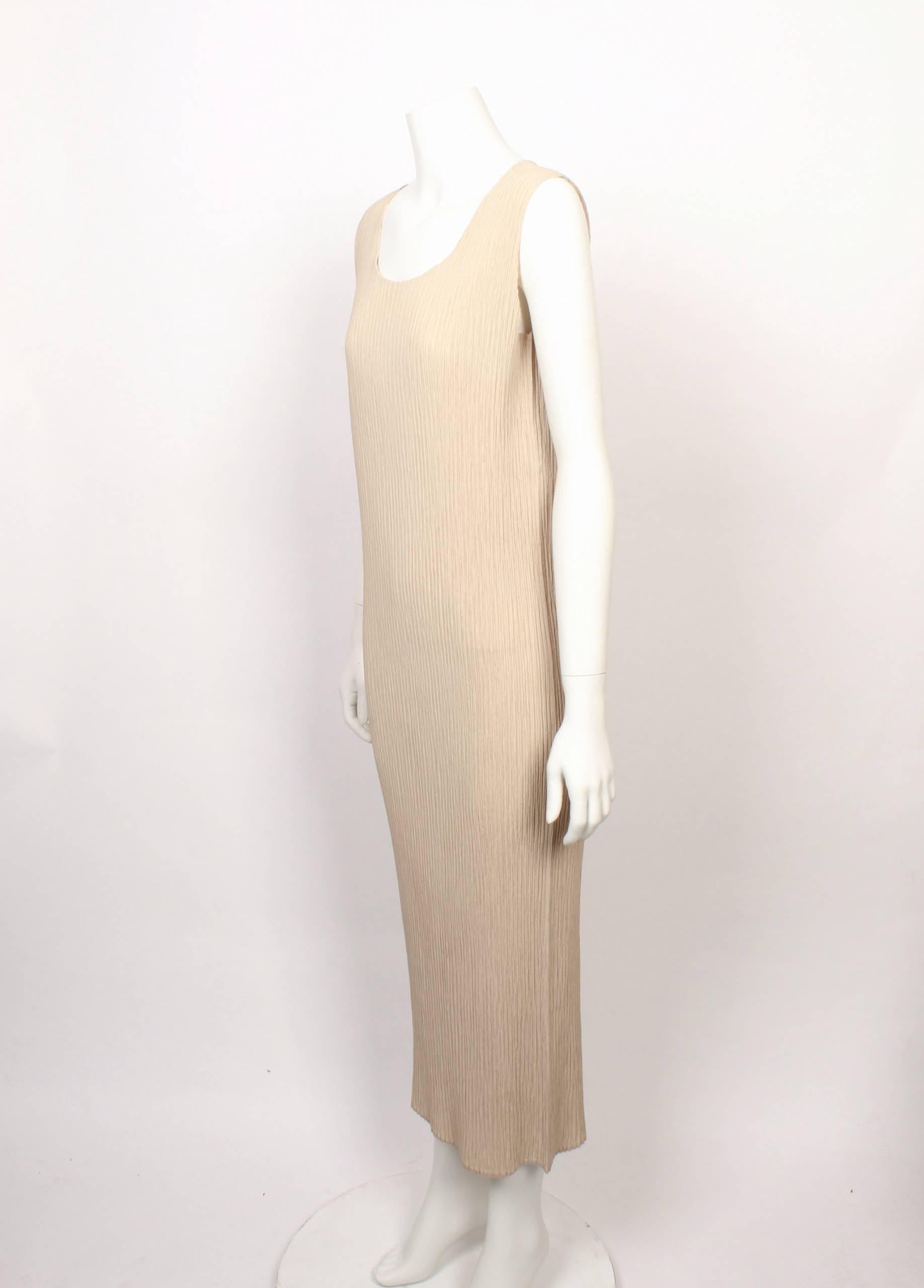 Classic yet always contemporary, 1990s Issey Miyake 3/4 length vanilla coloured sleeveless tank shift dress in iconic Issey Miyake pleats. 
Fabric is stretchy and measurements are with garment flat and un-stretched.