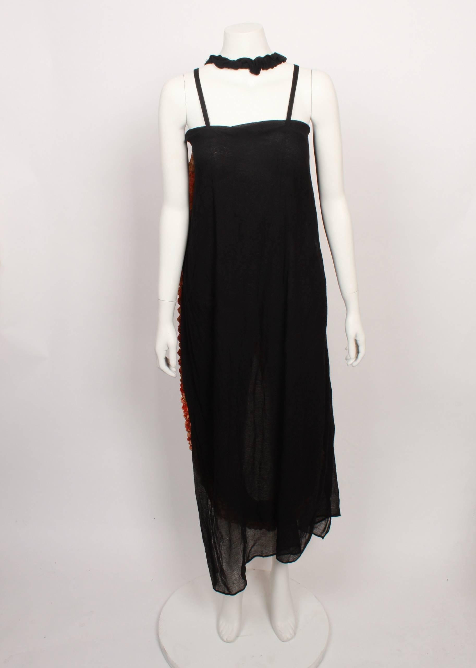  Yojhi Yamamoto draped origami dress in panels of solid black and multi orange hues.
This is a very unique Yamamoto piece incorporating traditional Japanese textile techniques such as shibori and yuzen dyed fabric. The dress is convertible and can