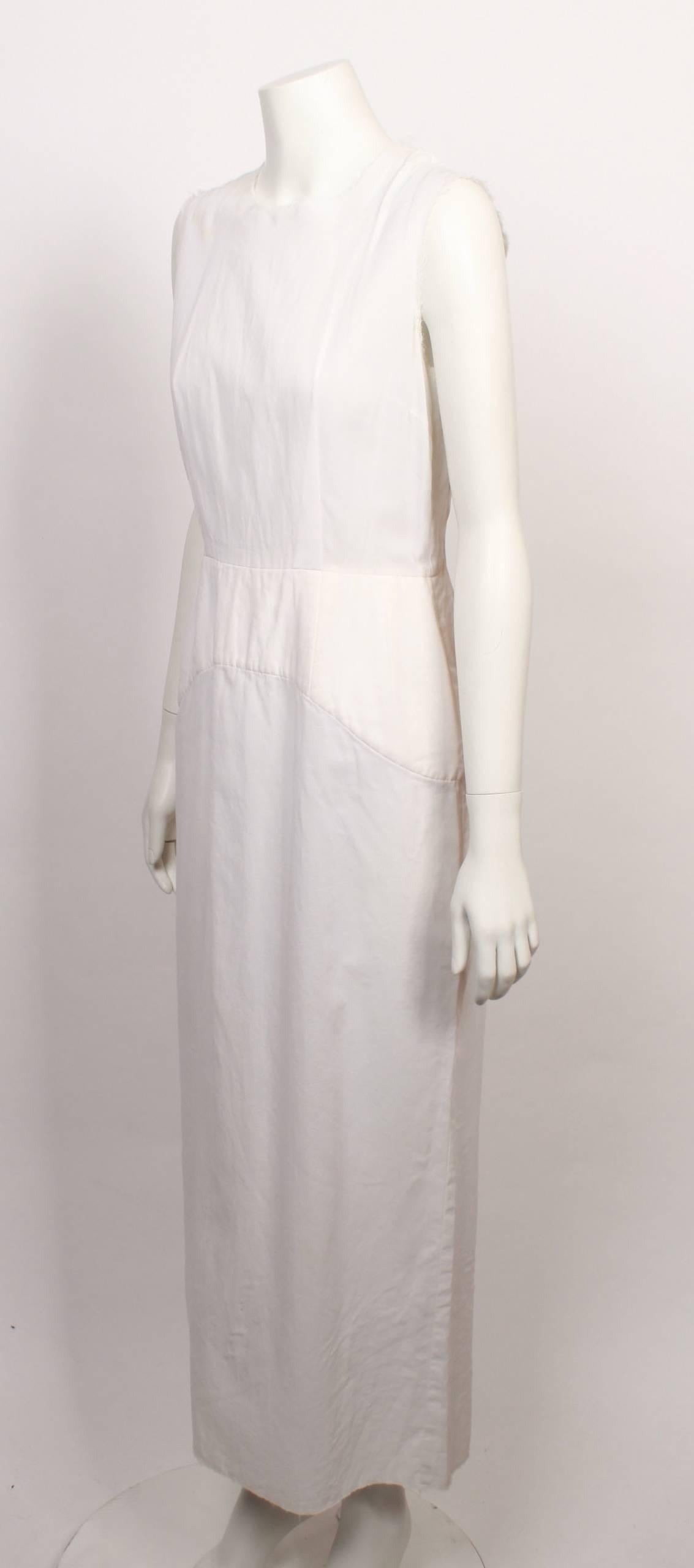 FINAL SALE
Madam Virtue & Co

Classic minimalist  Comme des Garcons  white sleeveless shell dress with yoke feature and raw edges on armhole and neckline. Care and size label missing. Measurements like a medium.
Made in Japan. 