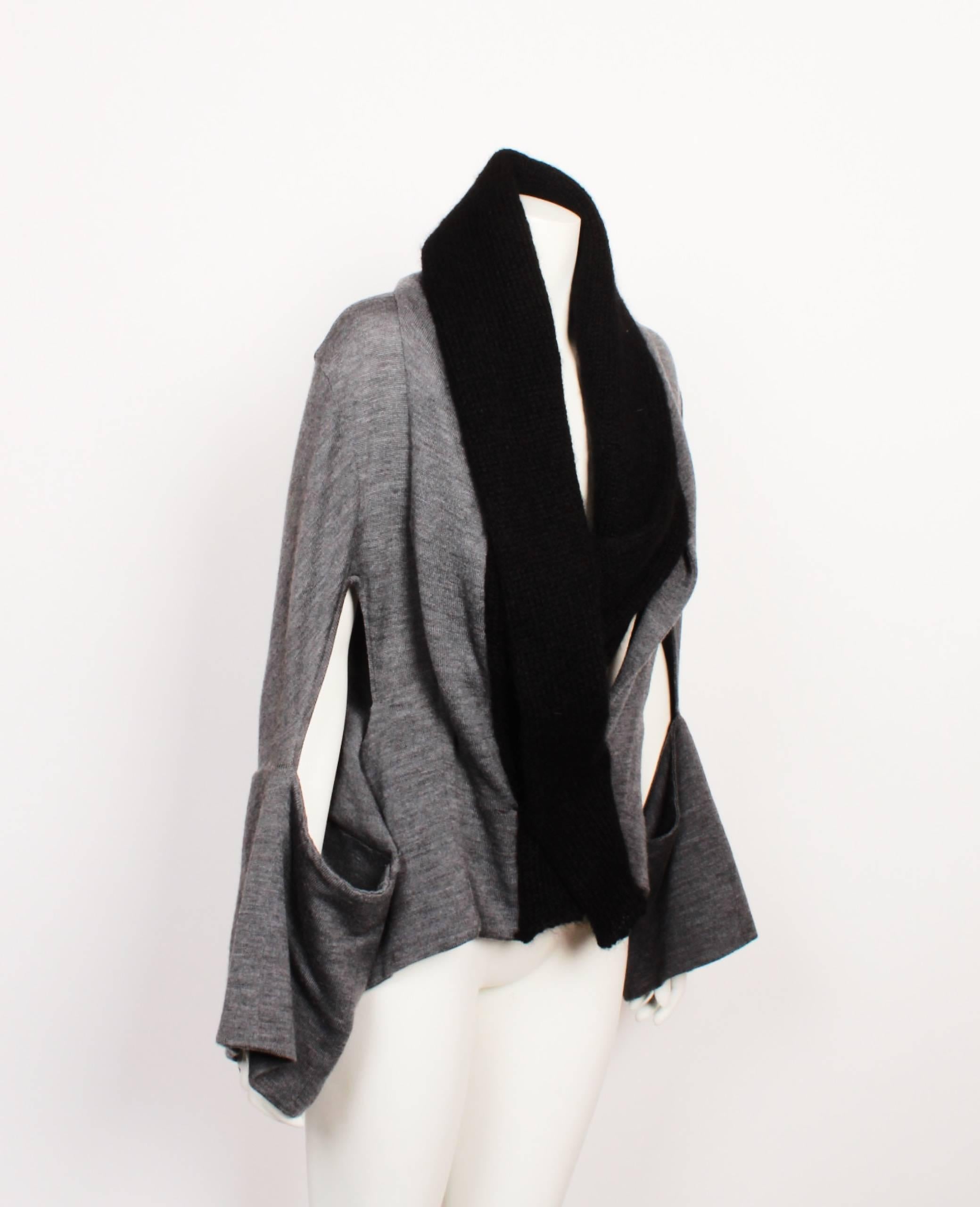 Yohji Yamamoto grey wool knit jacket. 
Deconstructed sleeves with black shawl-like front. 
Press Stud Closure & Tie wrap closure. 
