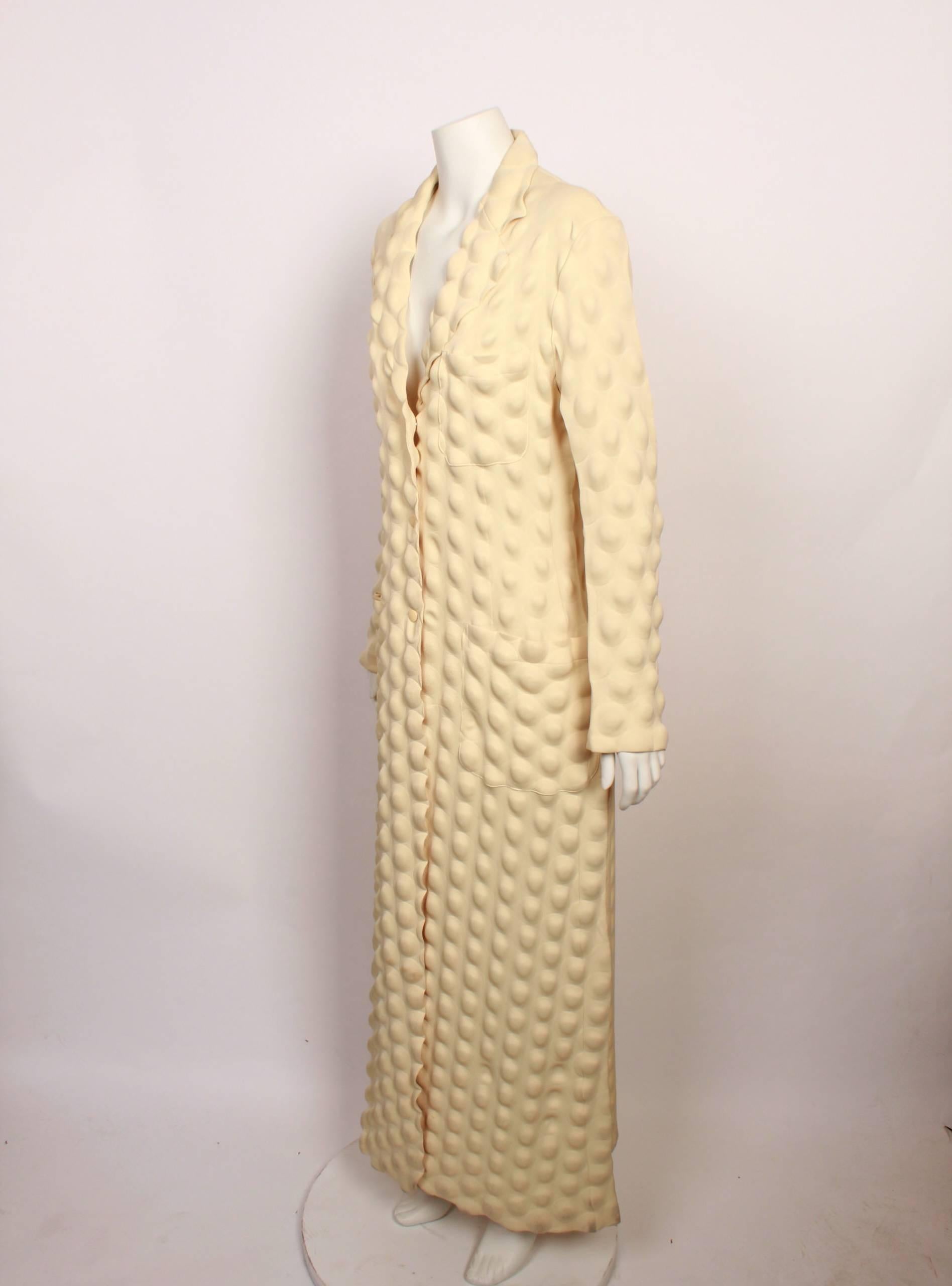 FINAL SALE - NO FURTHER DISCOUNT

Very rare  and iconic Issey Miyake Egg Carton coat in cream from the Fall / Winter 2000 Collection
Features all over rippled bubble imprint, single breasted, three cream snap closures at front, a breast pocket and