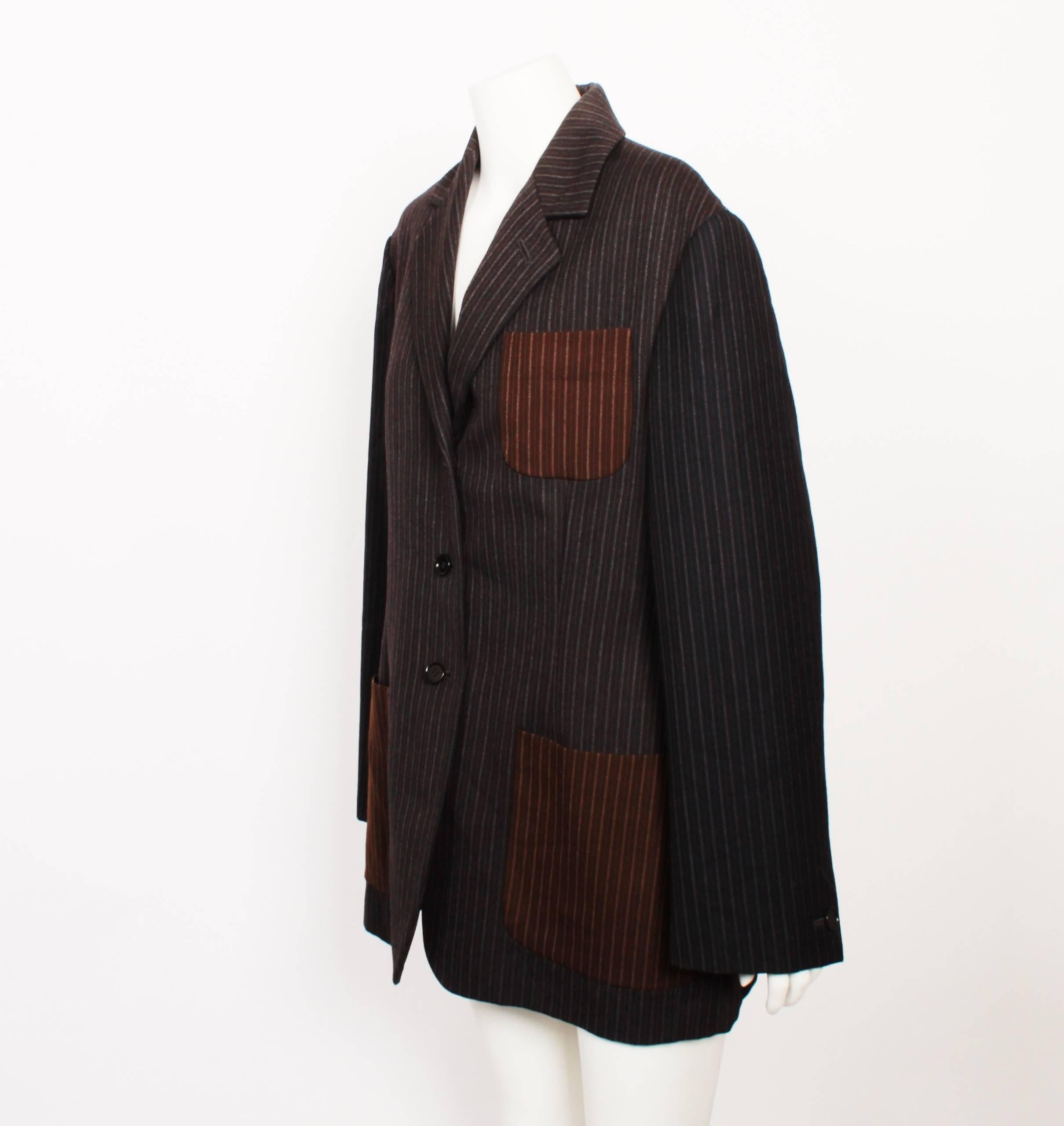 Romeo Gigli Blazer from Italy 1973.
Two tone grey pinstripe with brown pinstripe pocket detailing. 
3 Button detail. 
