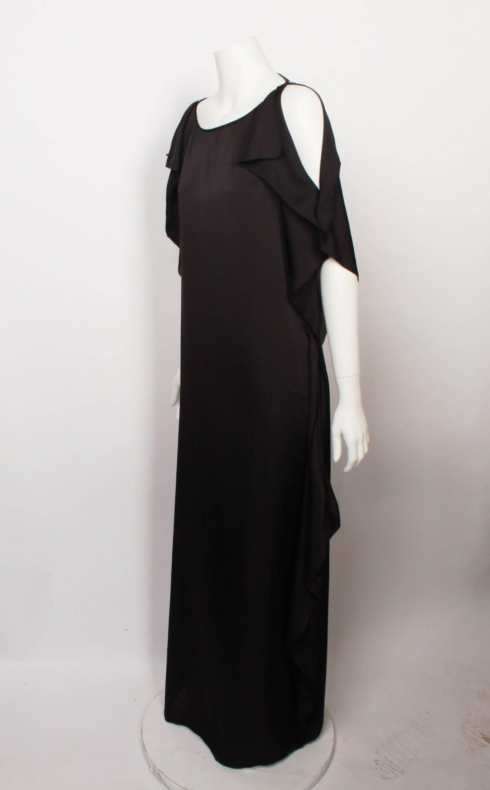 Sophisticated and luxurious Max Azria black silk handkerchief backless maxi dress. Features beautiful edge detail and the back is slashed to the waist and secured with a delicate spaghetti tie. 
Size Small. 