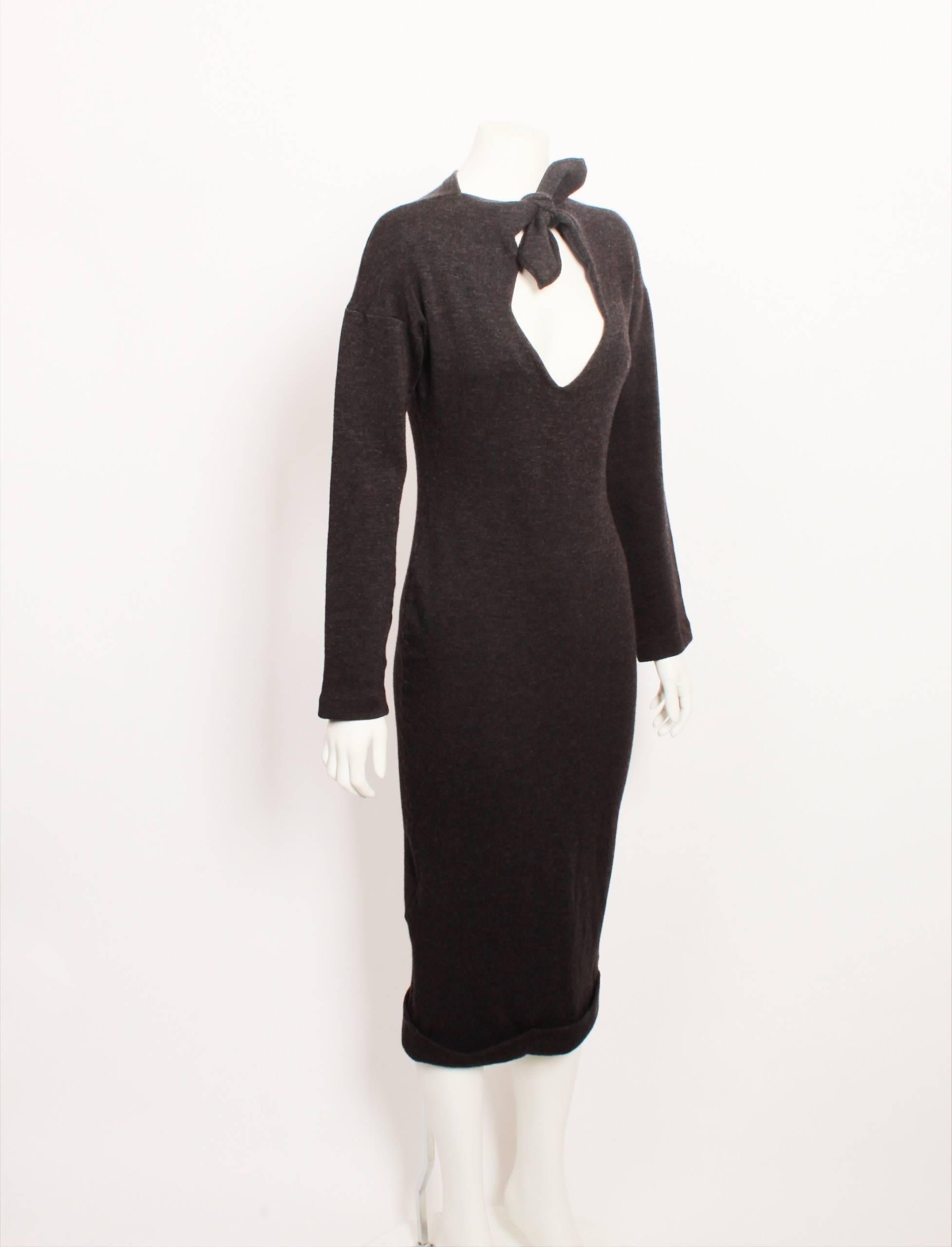 This Romeo Gigli charcoal grey long sleeve body con fitted sheath dress is made from thick wool jersey and features a diamond shaped key hole with petal shaped tie at the front neck. Hem has a cuff turned up finish. Measurements are taken with