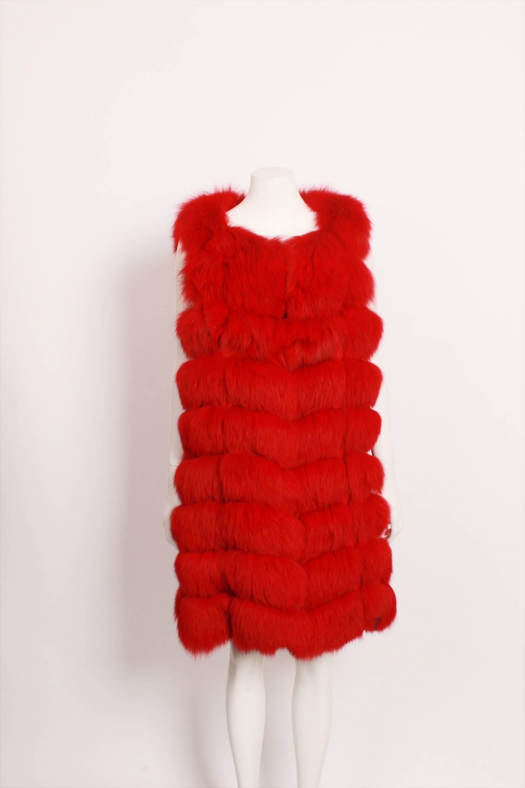 Very unique and luxurious bright red fox fur sleeveless vest features strips mounted on a backing to create a zig zag pattern. Front hook and eye closure, in seam side pockets and fully lined in red paisley acetate. Size medium.
