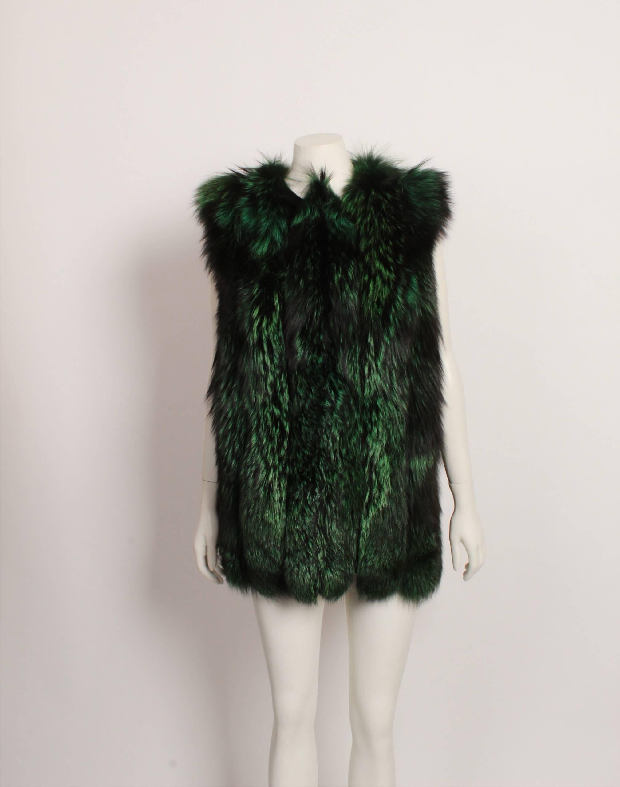 Very unique green and black fur sleeveless vest features vertical strips mounted on a black backing.  Front hook and eye front closure and fully lined in black self patterned acetate. Size small.