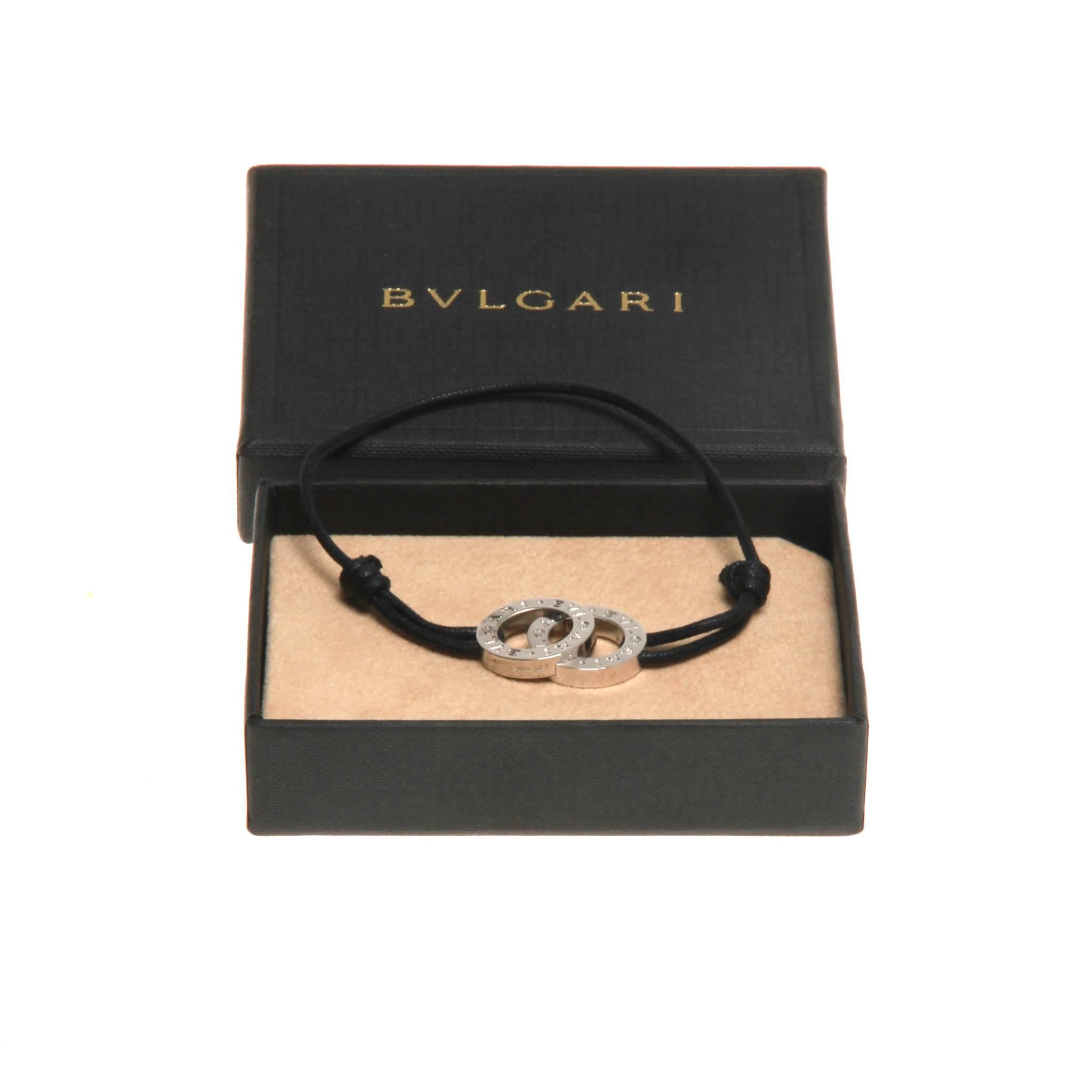 Navy cord Bvlgari Fortuna bracelet featuring sterling silver interlocking ring ornament with engraved logos and adjustable closure. Includes box.

Charm - 2.5 x 1.75cm / Strap - Diameter 7cm (adjustable).