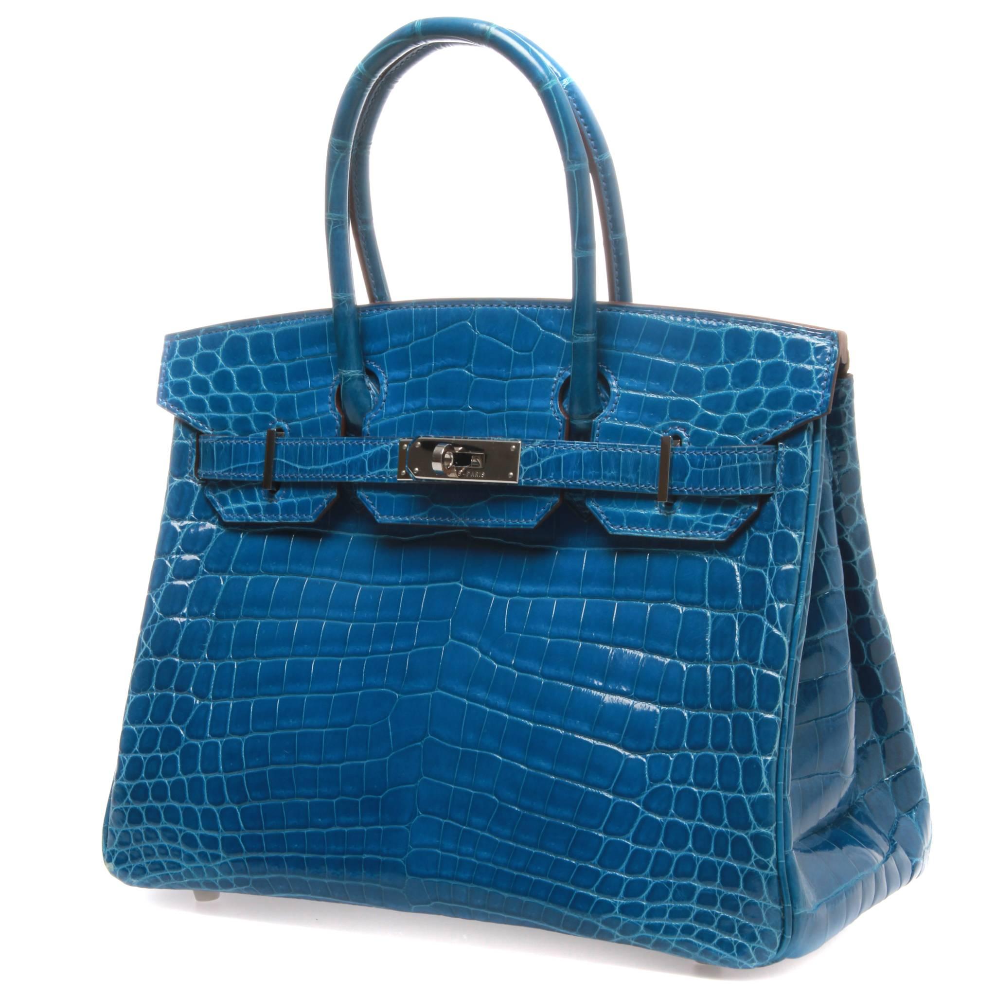 Enjoy a splash of Mykonos blue with this exclusive Hermès bag, made out of durable crocodile material that contributes to its luxurious design. 
Chevre interior and multiple pouches to store your belongings. The bag is simple and exquisite,
