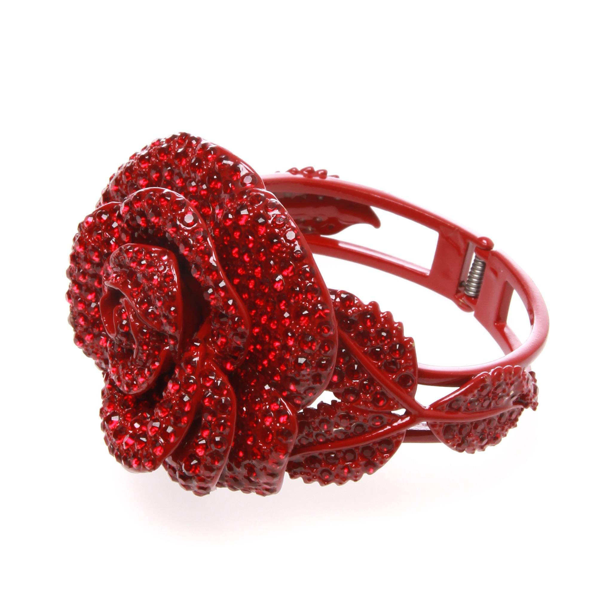 This is an eye-catching Valentino Garavani Swarovski Rose Cuff Bracelet.
It features a large rose with leaves, patterned with Red Swarovski Crystals throughout.
A spring mechanism provides a flexibility and room for the wrist.
Closure/ Opening: