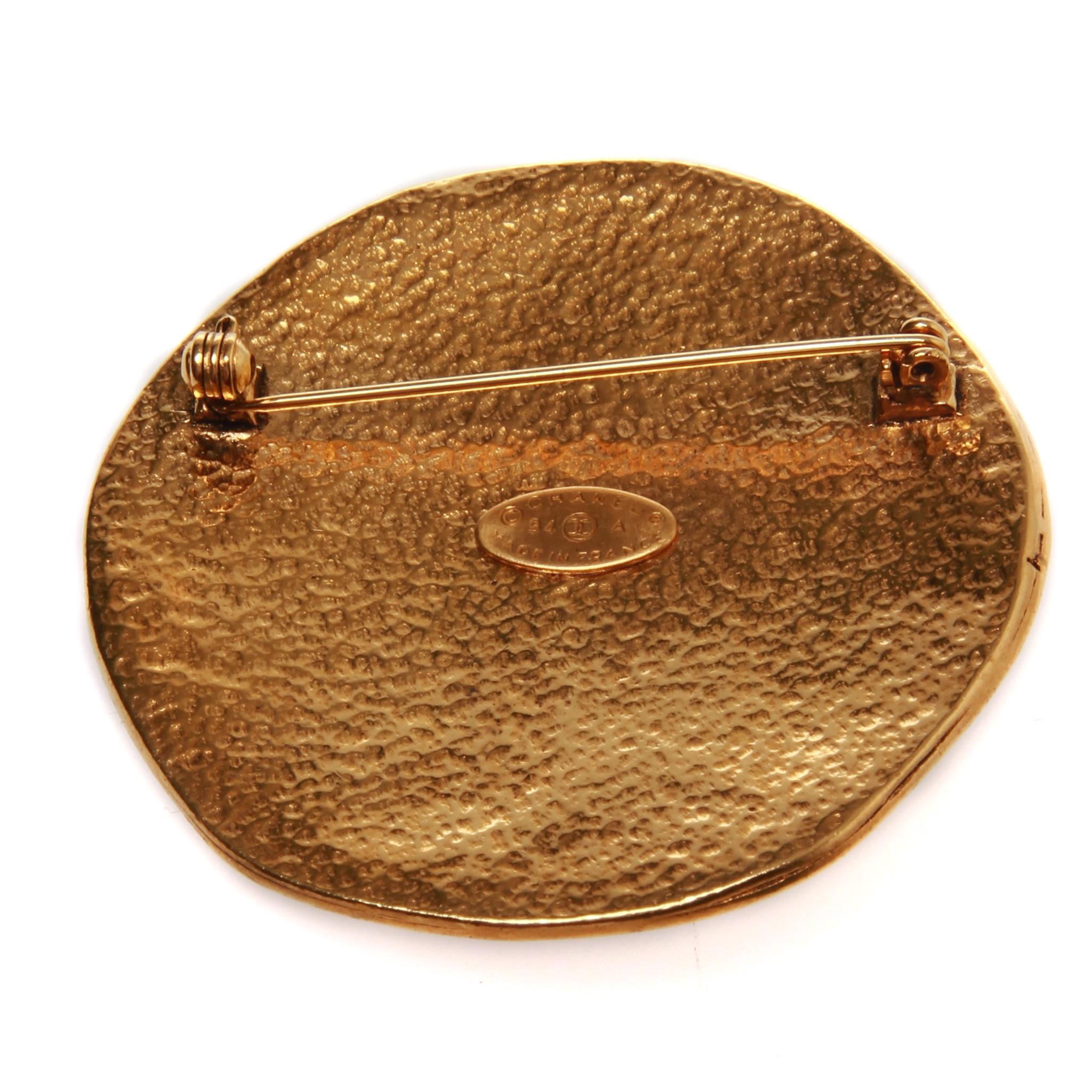 Chanel gold sun brooch with double CC, includes authentic Chanel box 