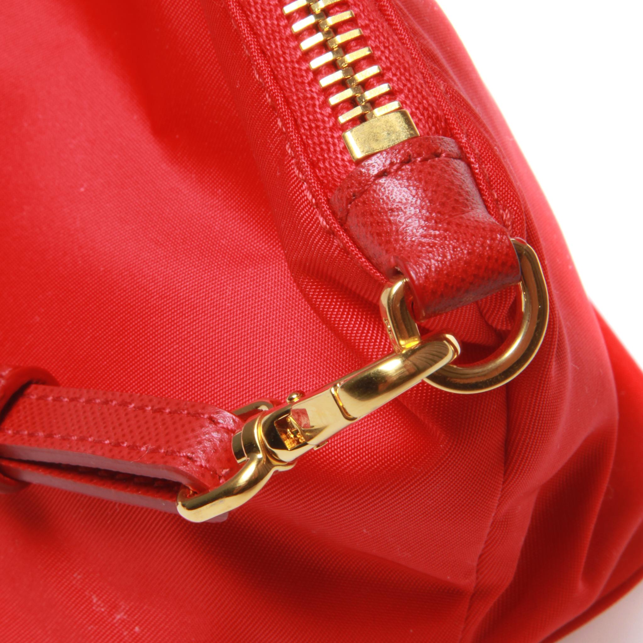 Red 	Prada small red clutch with gold hardware and red leather strap
