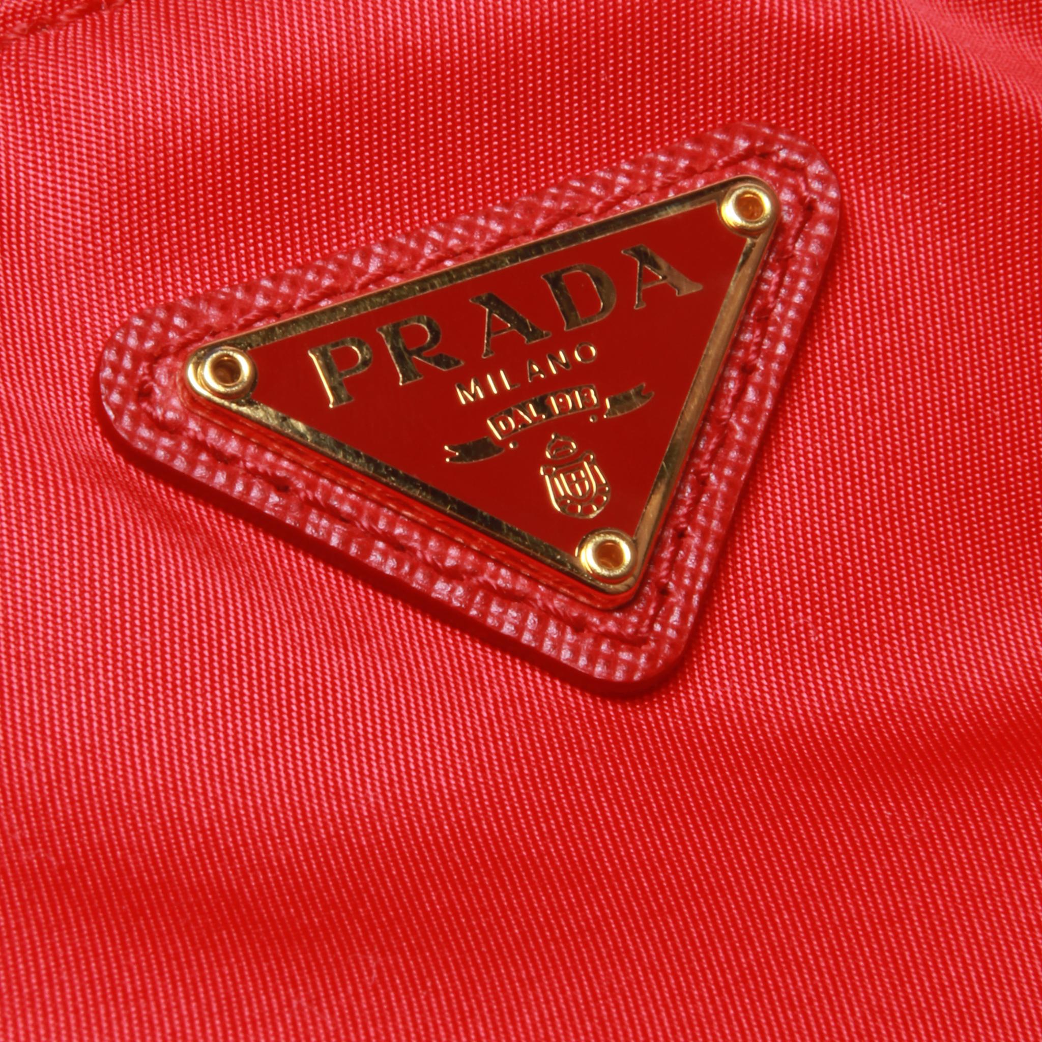 	Prada small red clutch with gold hardware and red leather strap In Excellent Condition In Melbourne, Victoria