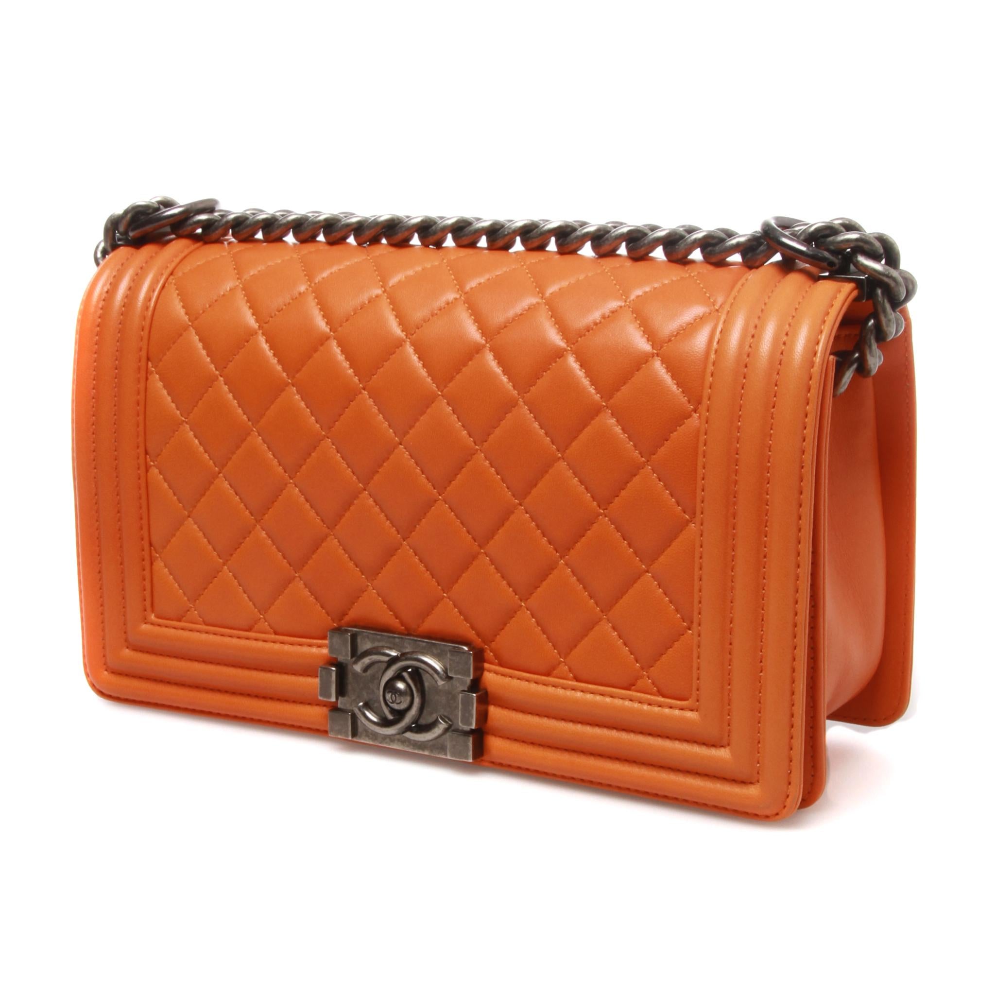 This collectable Chanel  Lambskin Quilted Medium Boy Flap Orange. 
This chic shoulder bag is crafted of diamond quilted luxurious lambskin leather with a linear quilted border in orange.
The bag features a ruthenium chain link shoulder strap with a