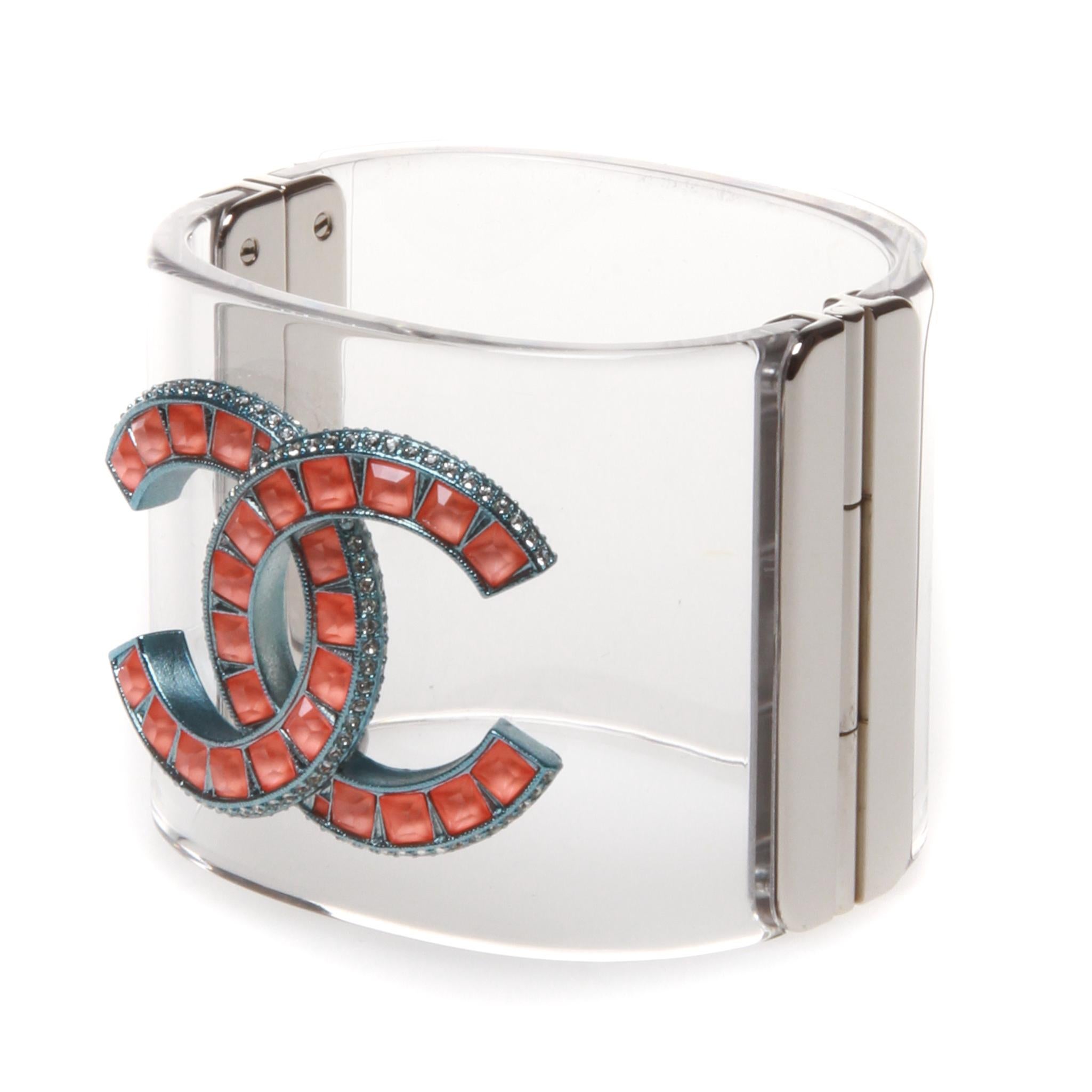 Chanel large clear cuff with large orange crystal embedded CC logo with box