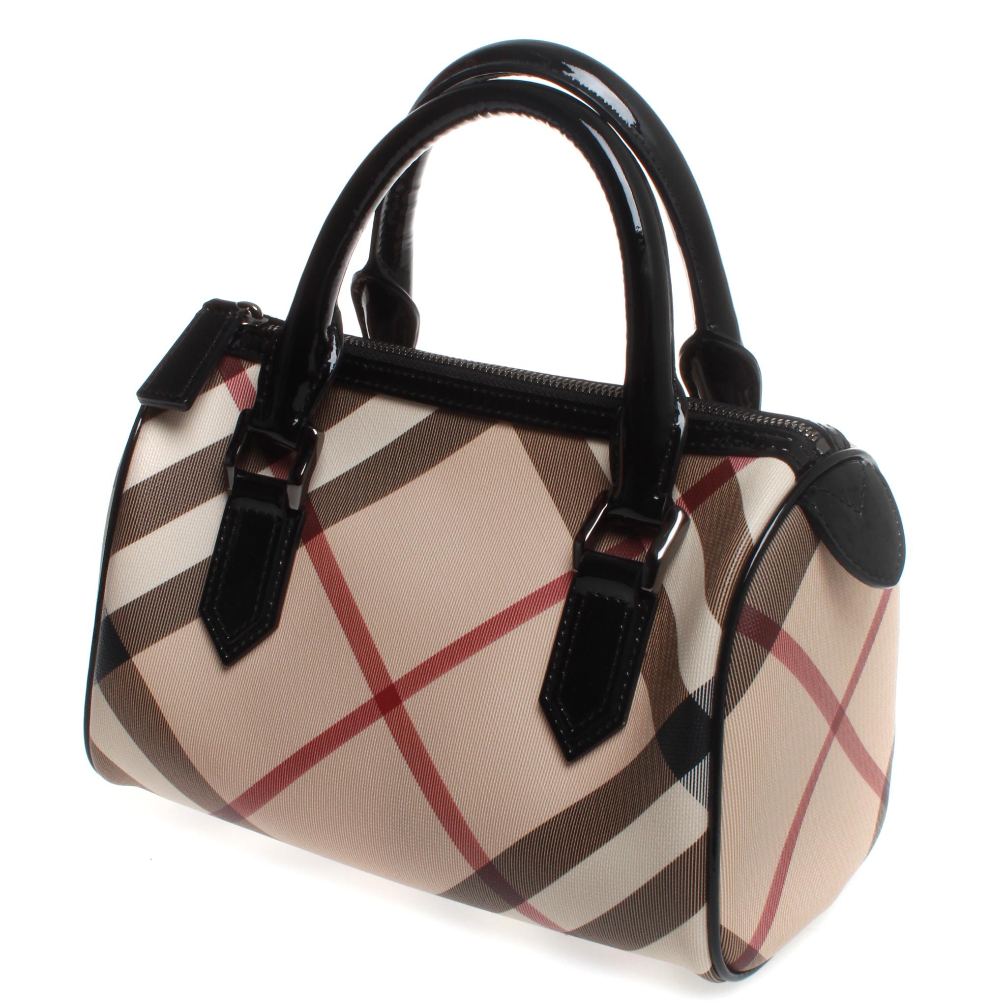 We guarantee this is an authentic Burberry Nova Check Small Chester Bowling Bag Black. This stylish tote is finely crafted of classic black, white, red and beige Nova check coated canvas. The bag features black rolled patent leather top handles and