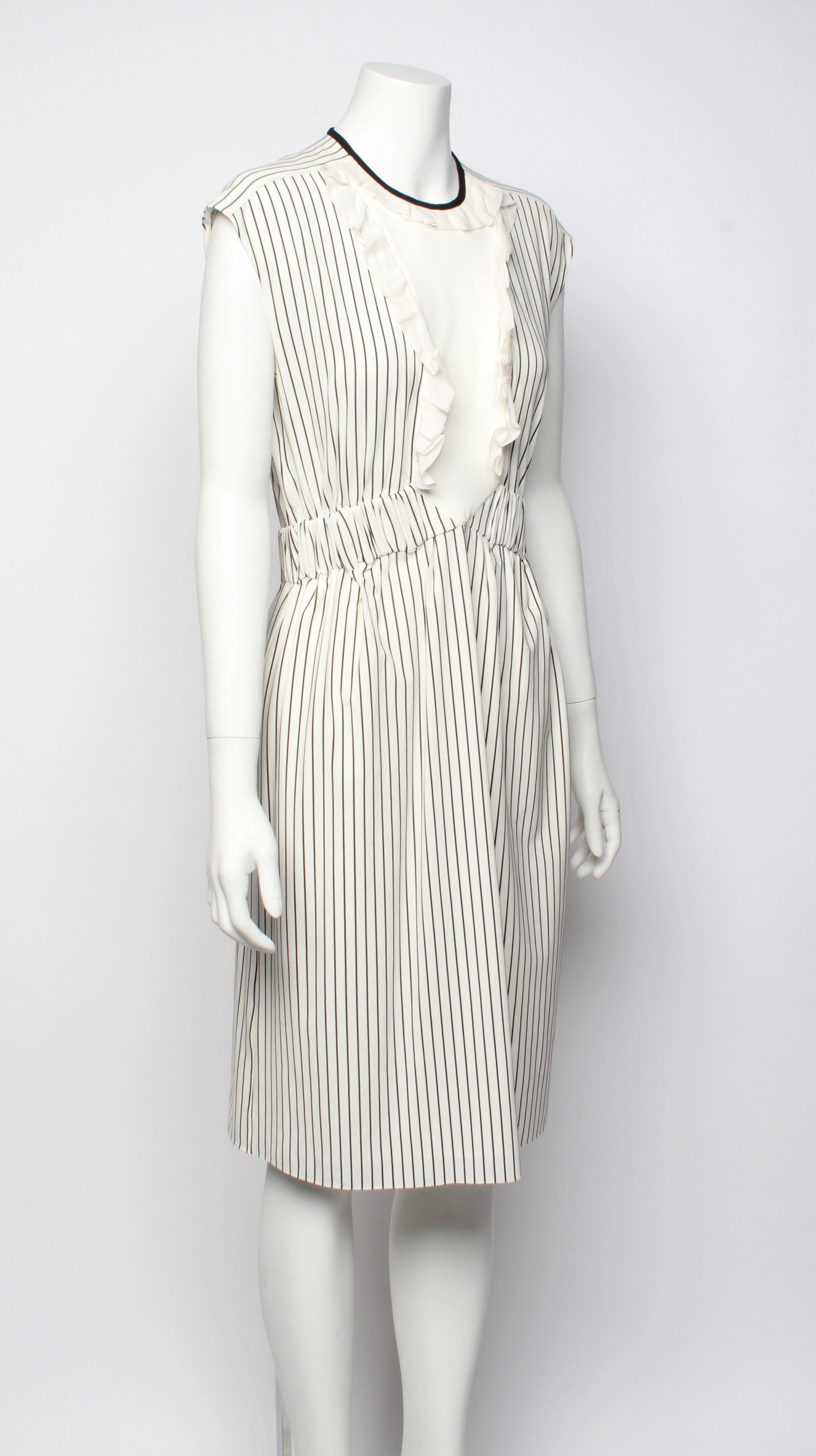 A beautiful and feminine Louis Vuitton stretch silk striped sleeveless dress with solid bib front panel, elasticated waistband feature and ruffle feature. Contrast binding around neckline. Fully lined with side zip closure. Has original tags