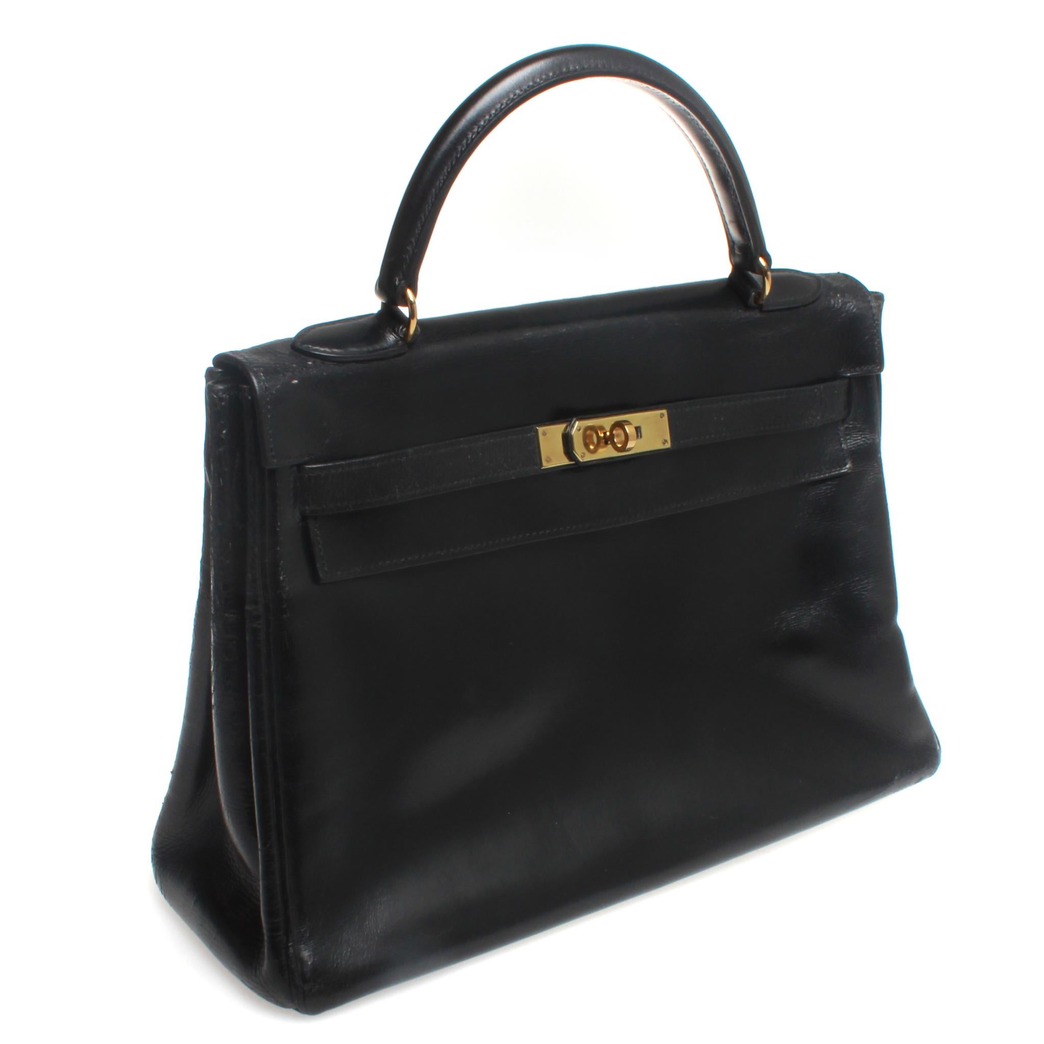 Hermes Kelly 1969, 32, Black with Padlock and Dust Covers - Black Box Calf Leather with Gold Hardware Purchased from Didier Ludot ( renowned Vintage seller in Paris ) Refurbed by Hermes Paris in 2013. In good Vintage condition Comes with Key,