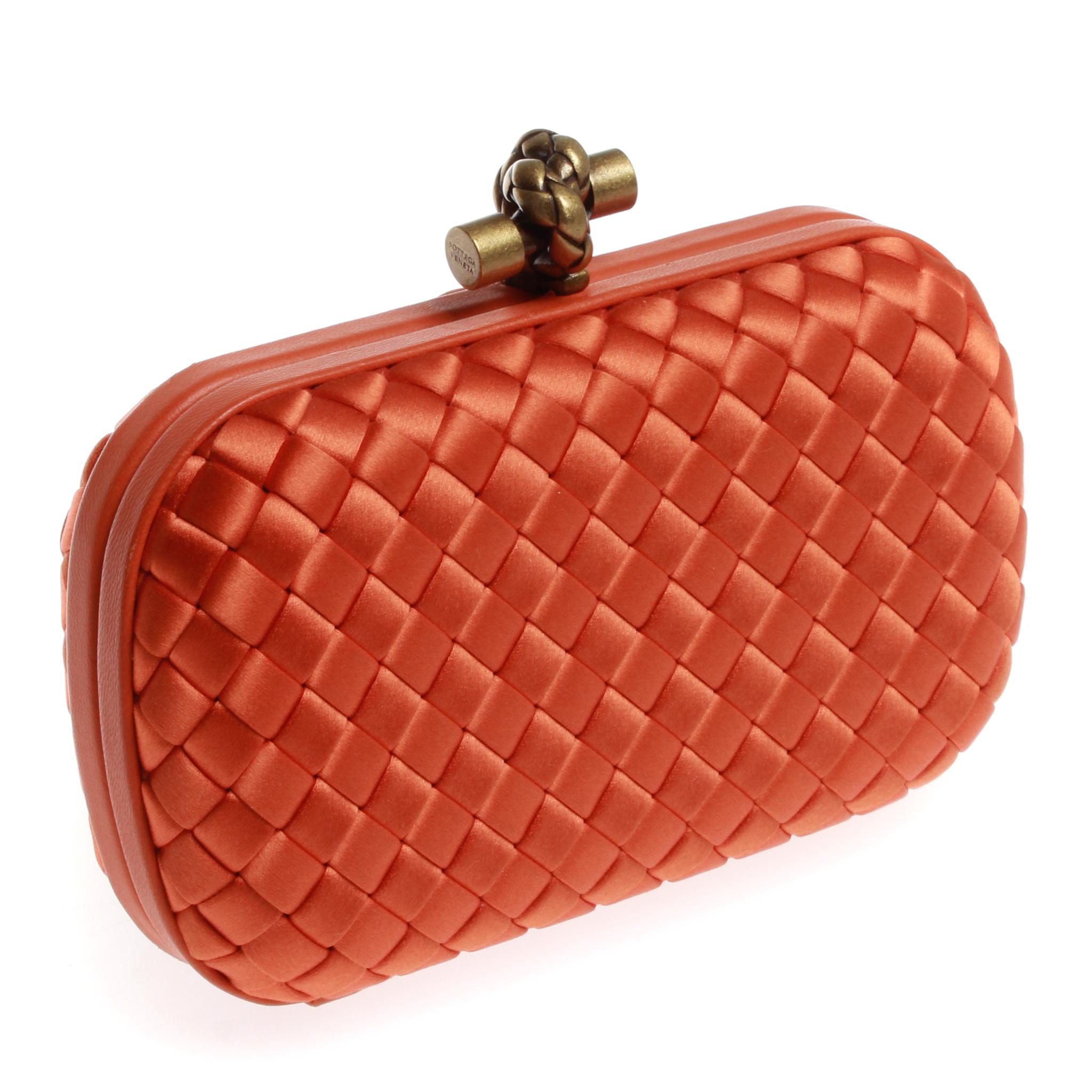 Bottega Veneta knot satin clutch in bright orange, with gold hardware and dust cover, in very good condition.