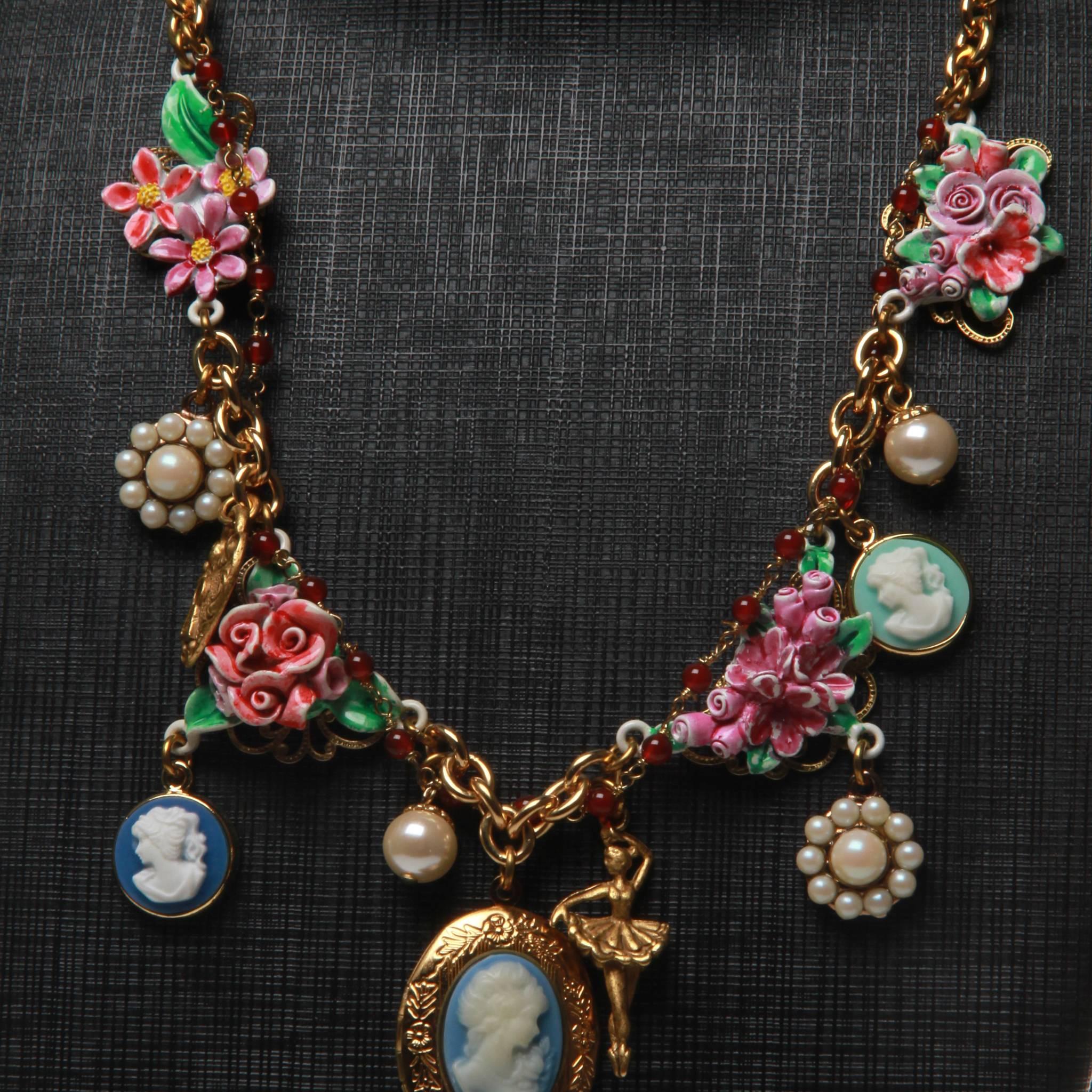 Made in Italy 

This lovely necklace is from the exclusive Main Line Dolce & Gabbana collection. It has been featured in several ad campaigns & on the runway. 
Lots of detail- It features a central blue cameo locket, smaller blue cameos, 