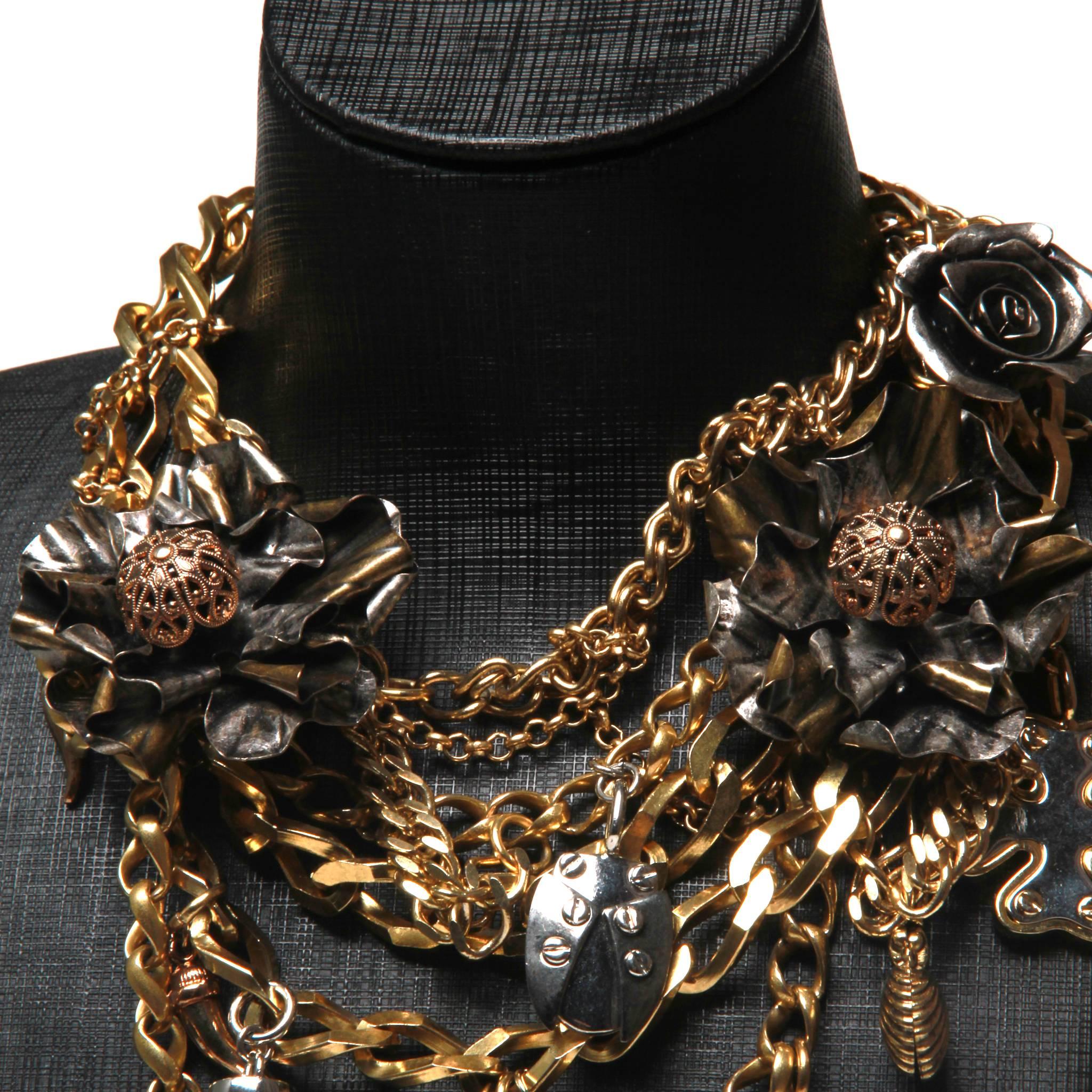 Straight off the runway, this Dolce & Gabbana  necklace is an amazing statement piece.  It sits high on the neckline and high quality charms include lockets, religious medallions, coin replicas, lucky horseshoe & padlock.
Tag shows US$2395