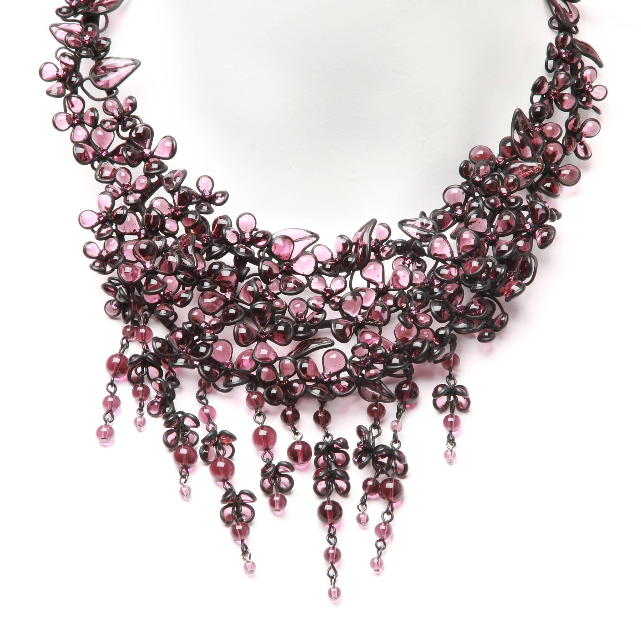 Beautiful Tom Ford necklace formed of intricate black metal and wire work and pate de verre glass in various tones of purple. 

Design features a solid frame with drop bead fringing for movement. Spring clasp closure at back. 