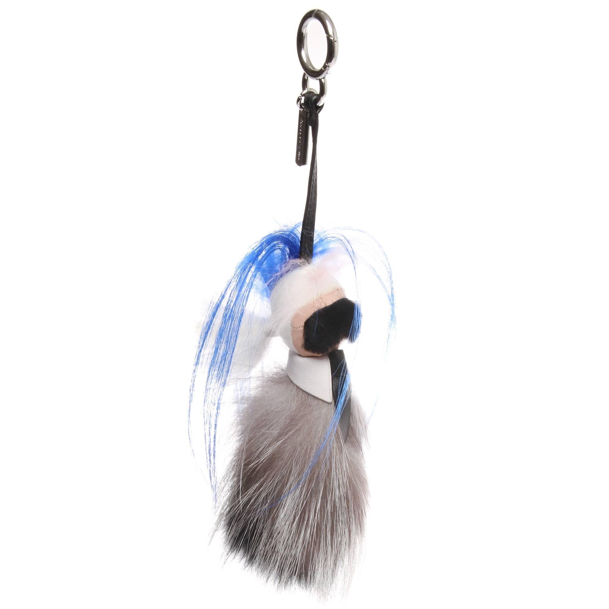 Authentic Fendi 'Mini Karlito' Bag Charm in mink and kidassia fur, with a pink tuft and a blue edge. Details and black calfskin leather laces. Palladium-finish spring clip and tag. Limited edition. Total length: 30cm, length of charm: 19cm.

Made in