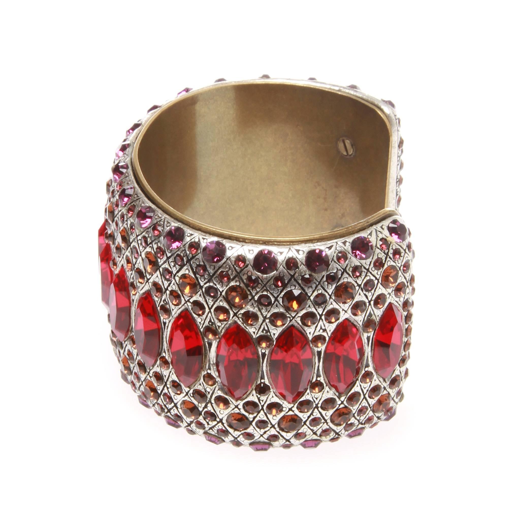Lanvin cuff embellished with red, apricot orange and magenta Swarovski crystals set in an aged silver and brass-finish support. Crafted in an open cuff style the cuff is fully encrusted with crystals and is a highly sought after piece of Lanvin