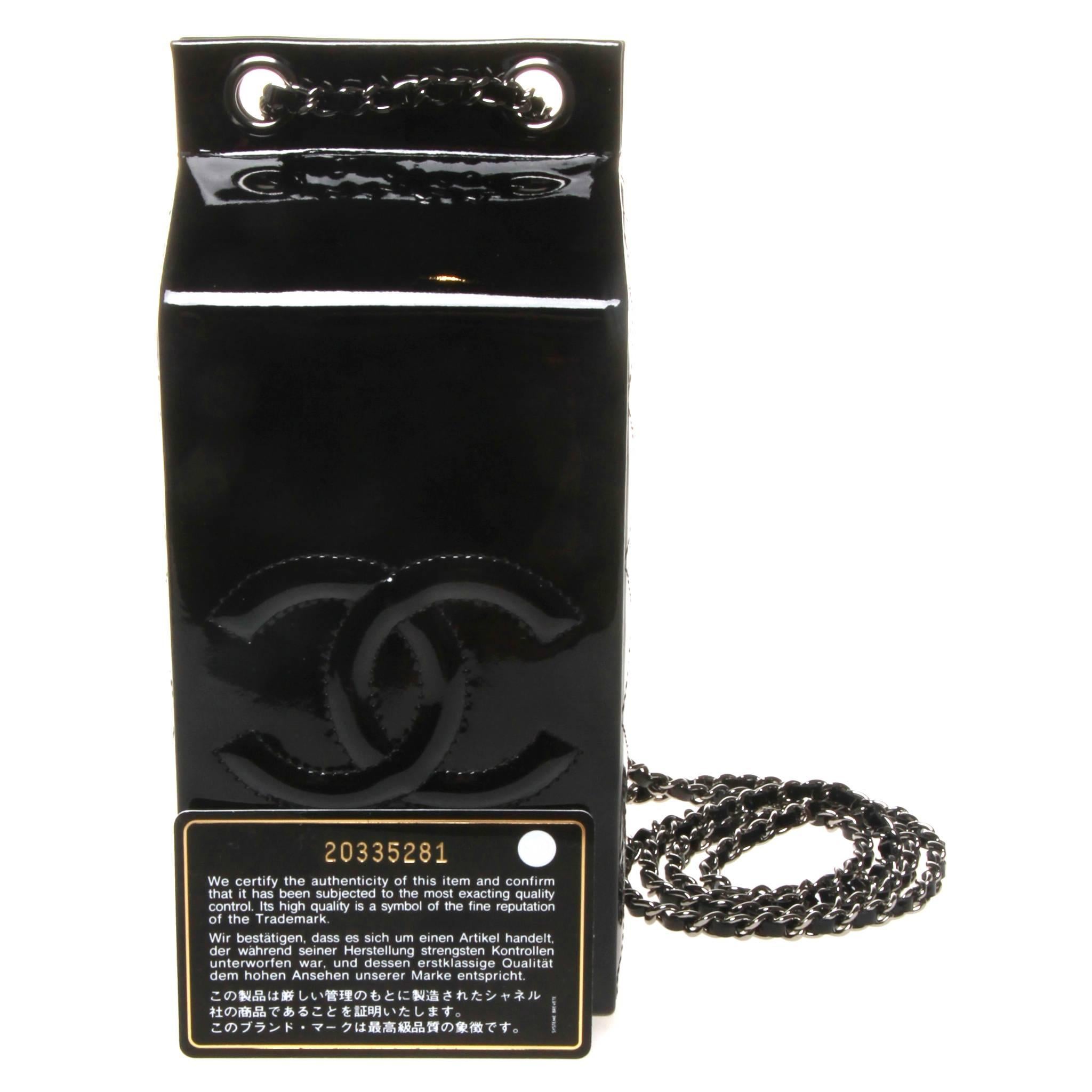 Rare limited edition Chanel milk carton bag from the luxury supermarket inspired Fall 14 ready-to-wear collection. Crafted allover of black patent leather and offset by the iconic threaded chain strap with patent leather and silver-tone hardware. 