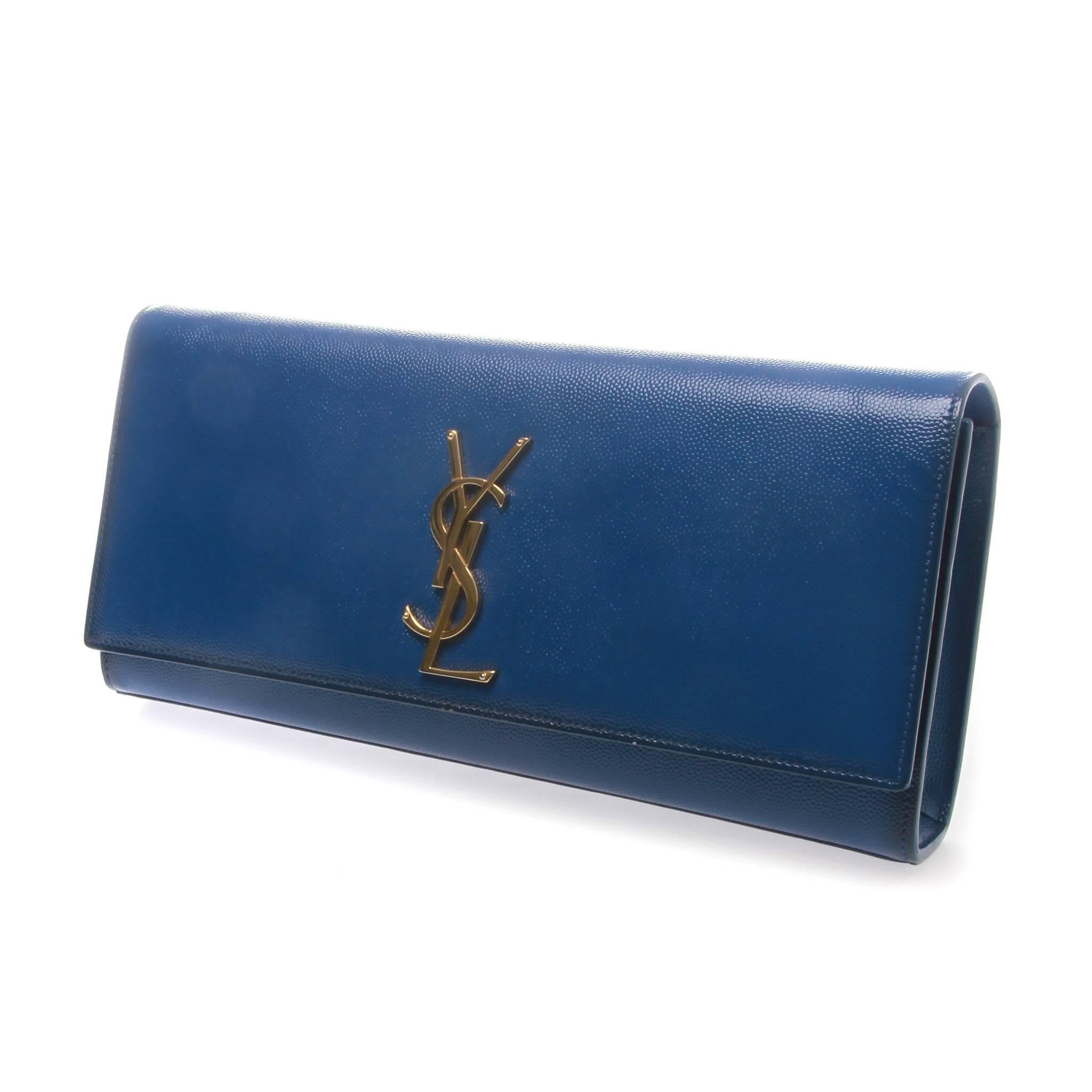 In a coveted Saint Laurent bag style, this electric blue rendition of the Cassandre clutch in a glossed cuir veau features a single main compartment with front flap closure. The monogram plaque features as centrepiece in gold-tone mental. This piece