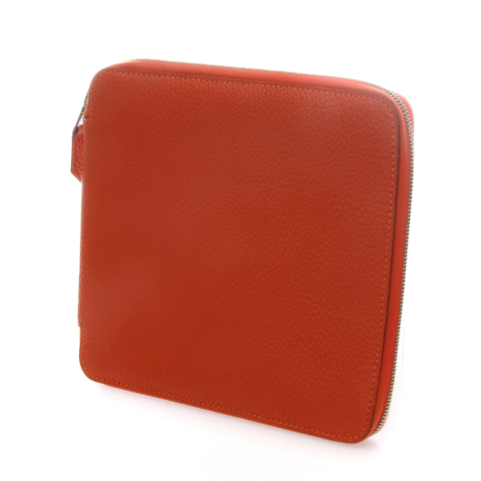 Highly collectable Hermès Orange Togo Leather CD Case.

An iconic orange colour togo leather CD case made in 2006.
It features 2 open pockets with 12 CD slots inside and a silver-tone zipped closure.