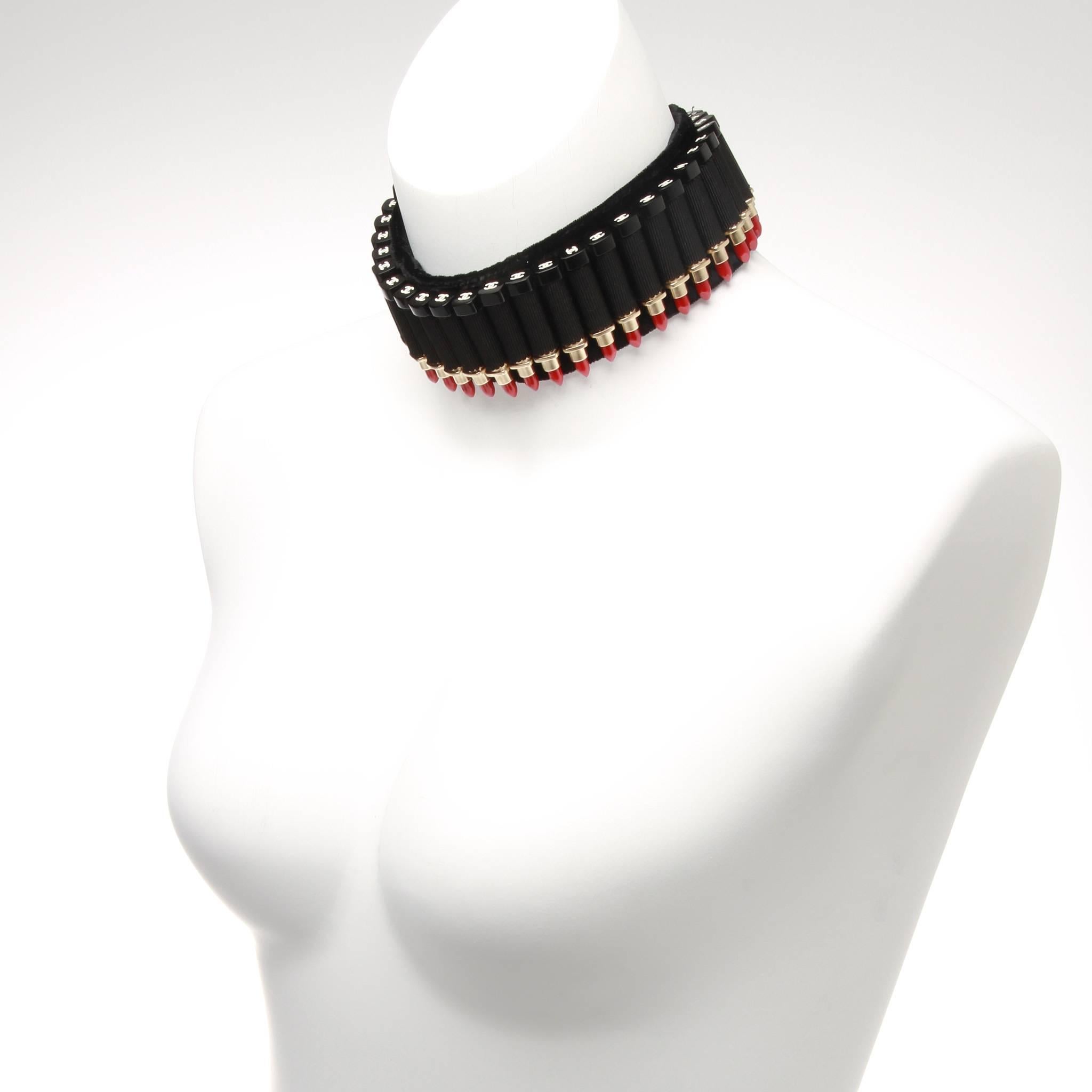 A rare Chanel choker masterfully crafted of red lipsticks strung so as to look like bullets on a rich black velvet bandolier. Iconic CC logo at the end of each lipstick. 

Fastener: Stamped silver hook at back. Comes with original and authentic box.