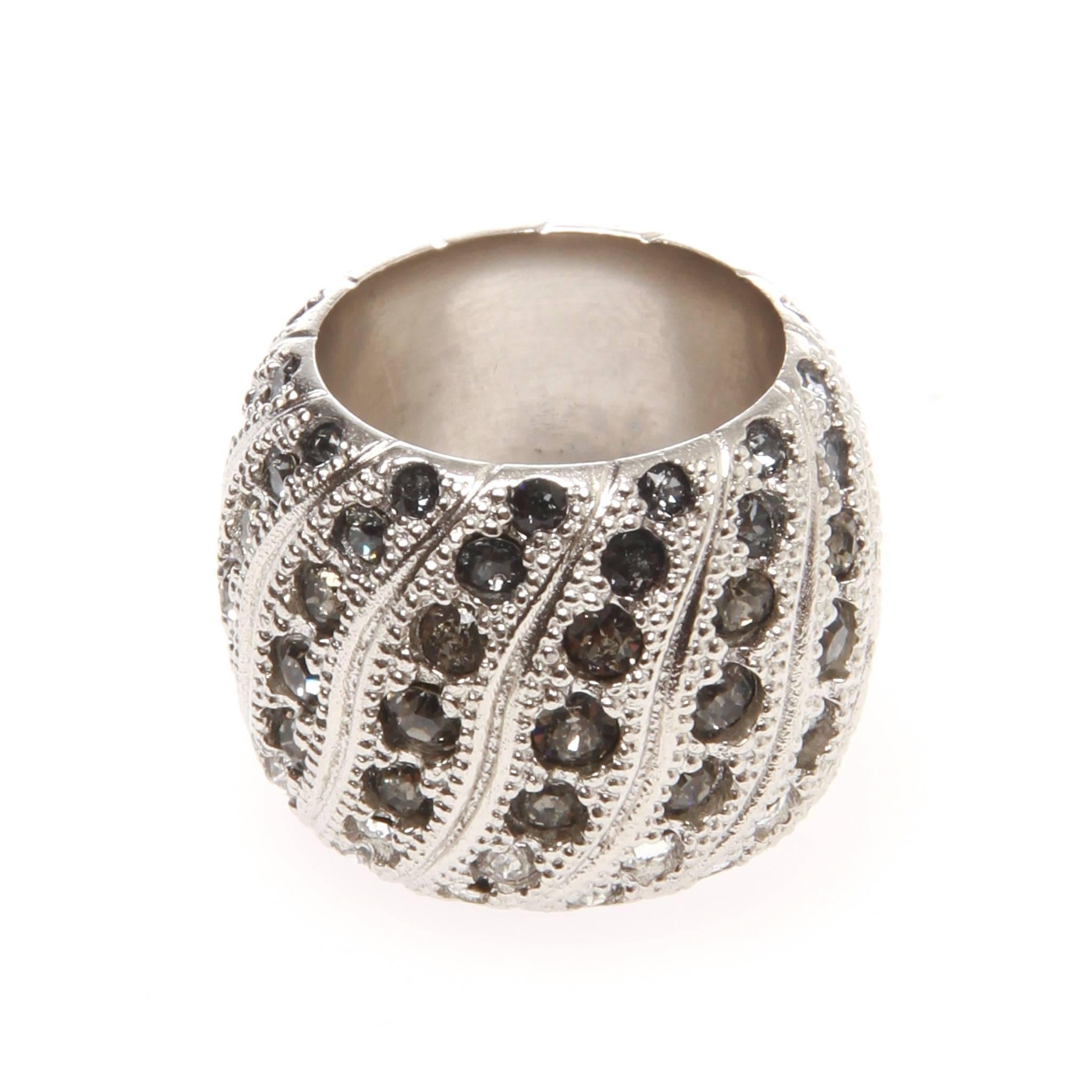 Chanel paved gun metal Swarovski crystal silver-tone ring from the Cruise 2016 collection. Beautiful wide-set band with continuous curving lines of bright cut crystals.

Date stamp reads B16 C

Pre-owned with no signs of wear

Ring Size: 54
US Size: