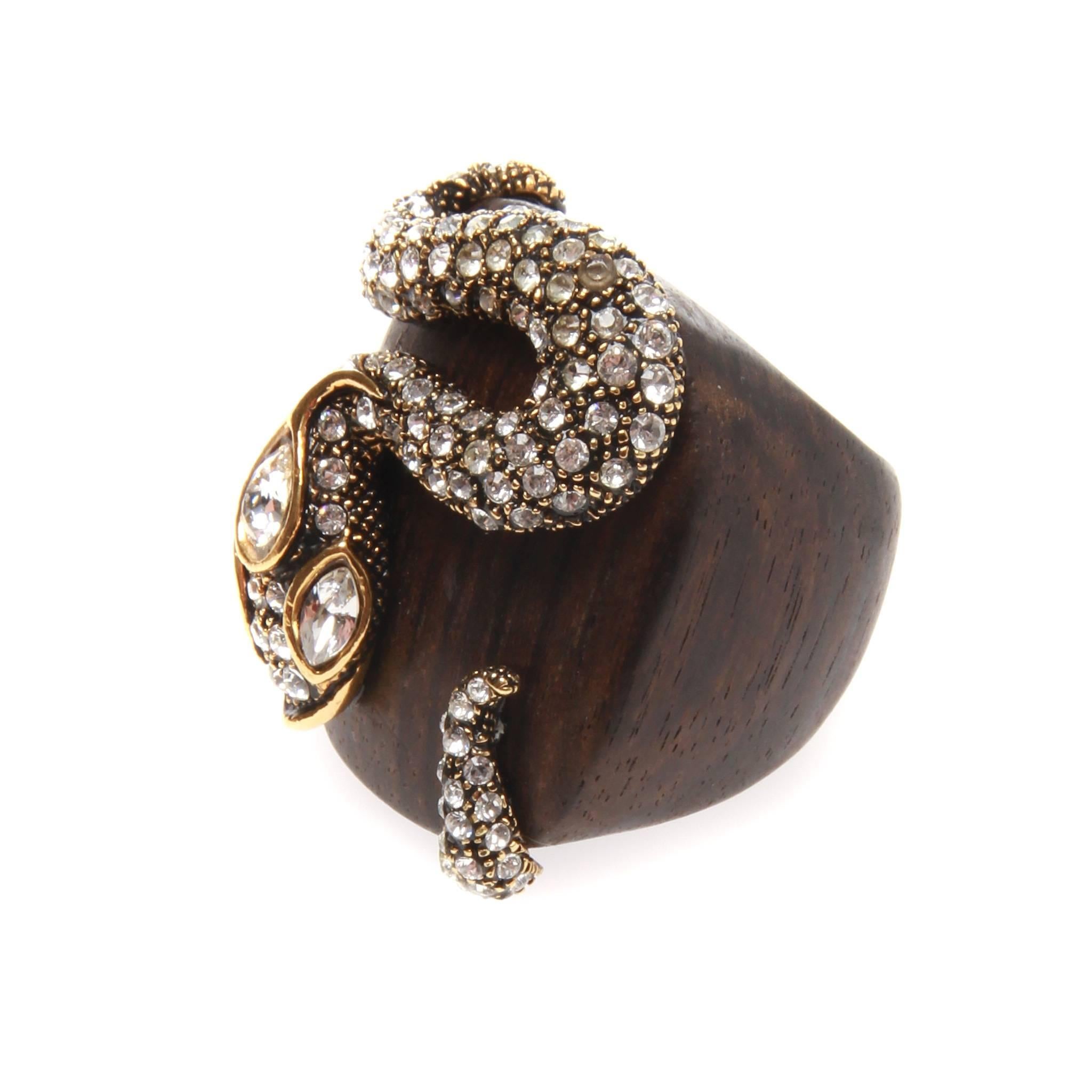 Striking Roberto Cavalli ring featuring a dark wood base and intricate gold-tone metal and Swarovski serpent detail. 

Size: US 7 

