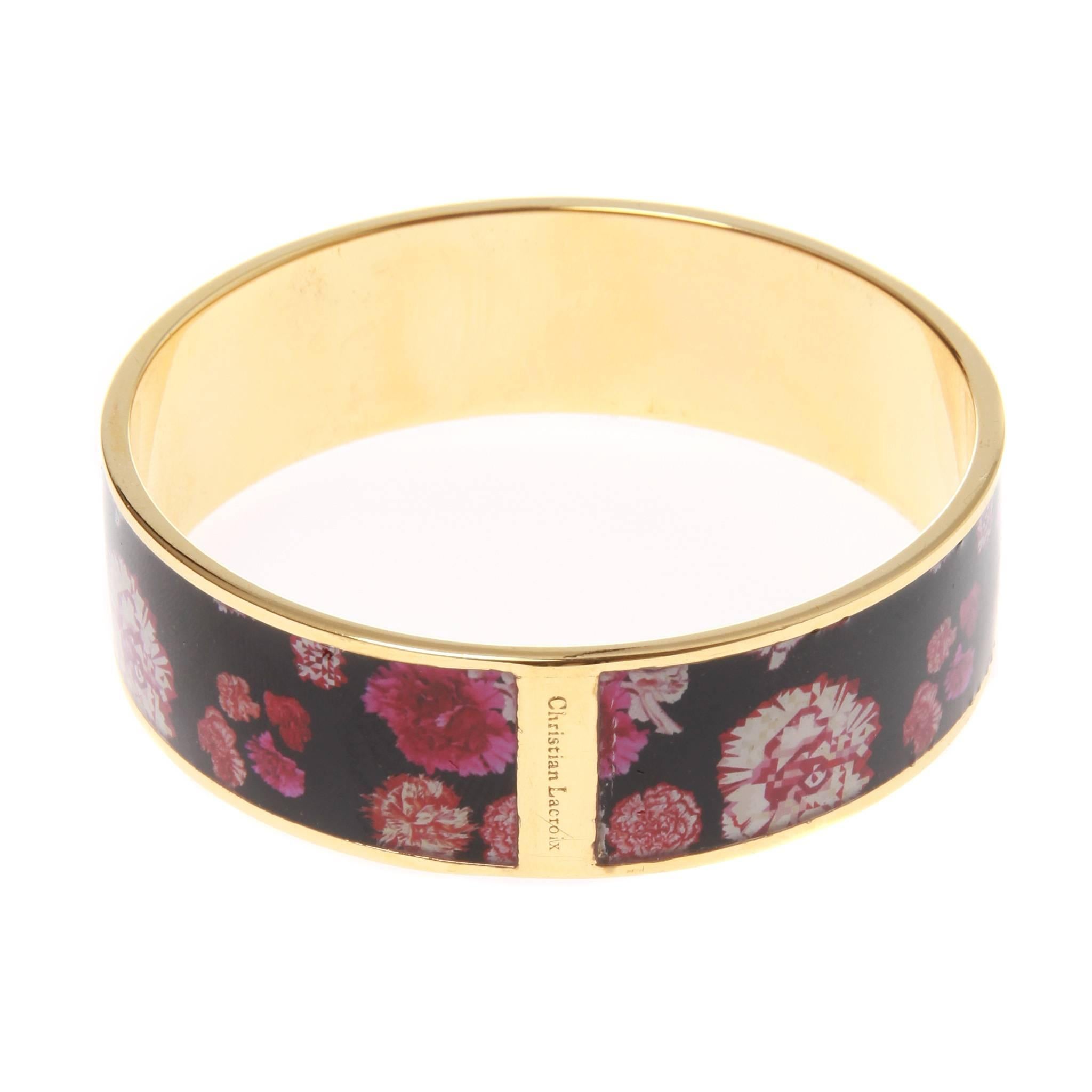 Christian Lacroix floral printed enamel and gold-tone metal bangle. Beautiful print in pink flowers set against a striking black background. 

Designer name embossed on outside at break in print. 

